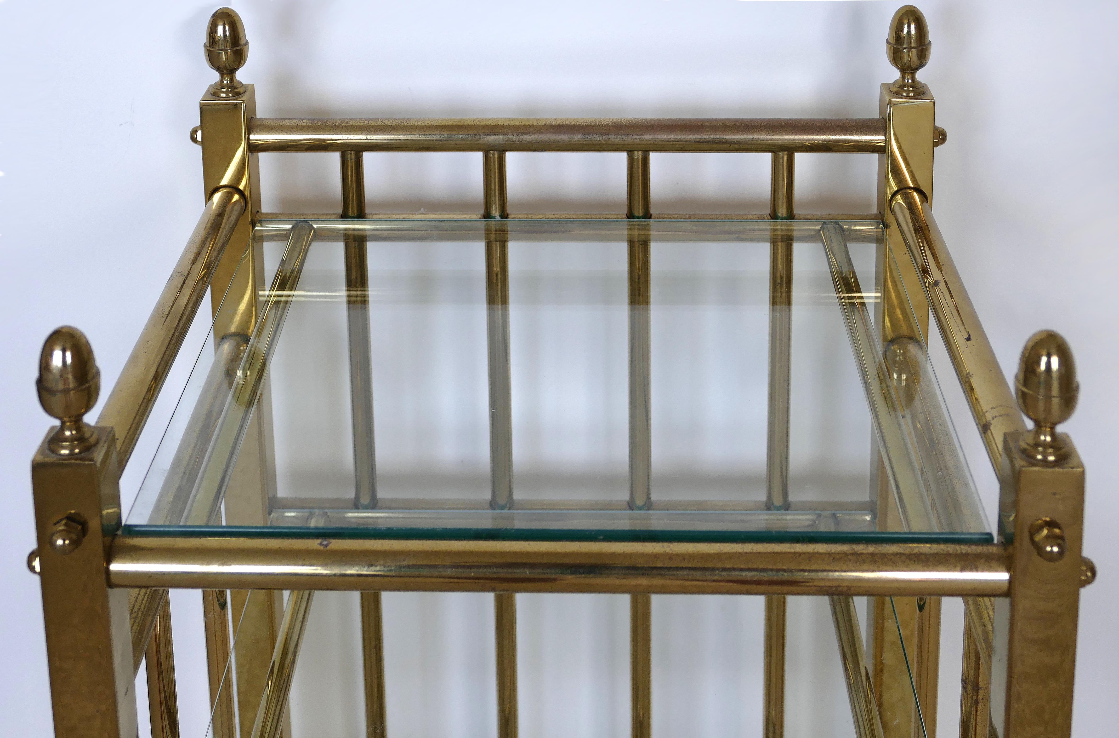 Petite 3-tier brass rolling cart side table with glass shelves

Offered for sale is a traditionally styled petite 3-tier rolling brass cart which functions nicely as a side table. The cart is created in brass with each tier supporting a thick