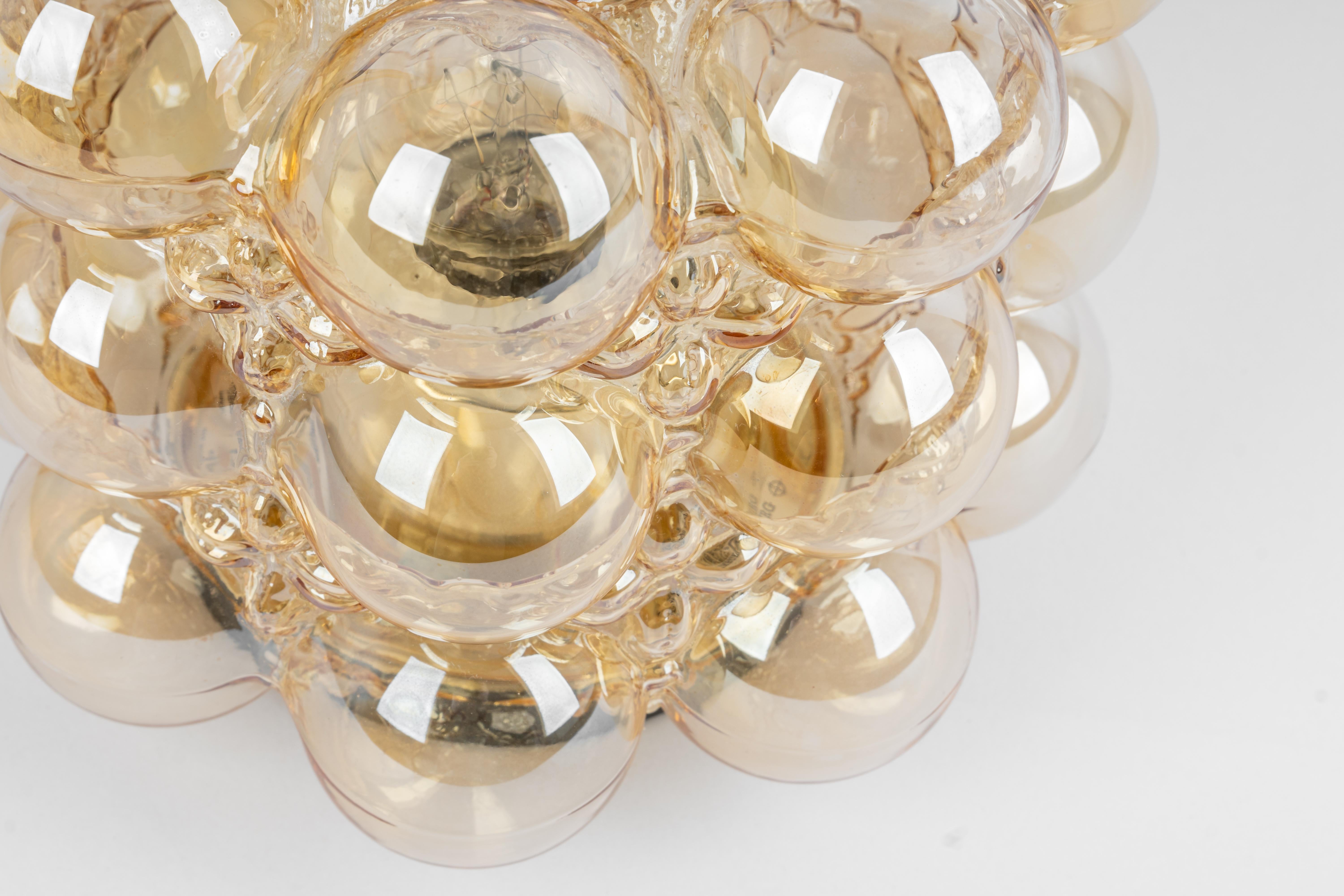 Amber bubble glass sconce by Helena Tynell, Limburg, Germany.
High quality and in very good condition. Cleaned, well-wired, and ready to use. 

Each Sconce requires 1 x E27 Standard bulbs with 60W max each 
Light bulbs are not included. It is