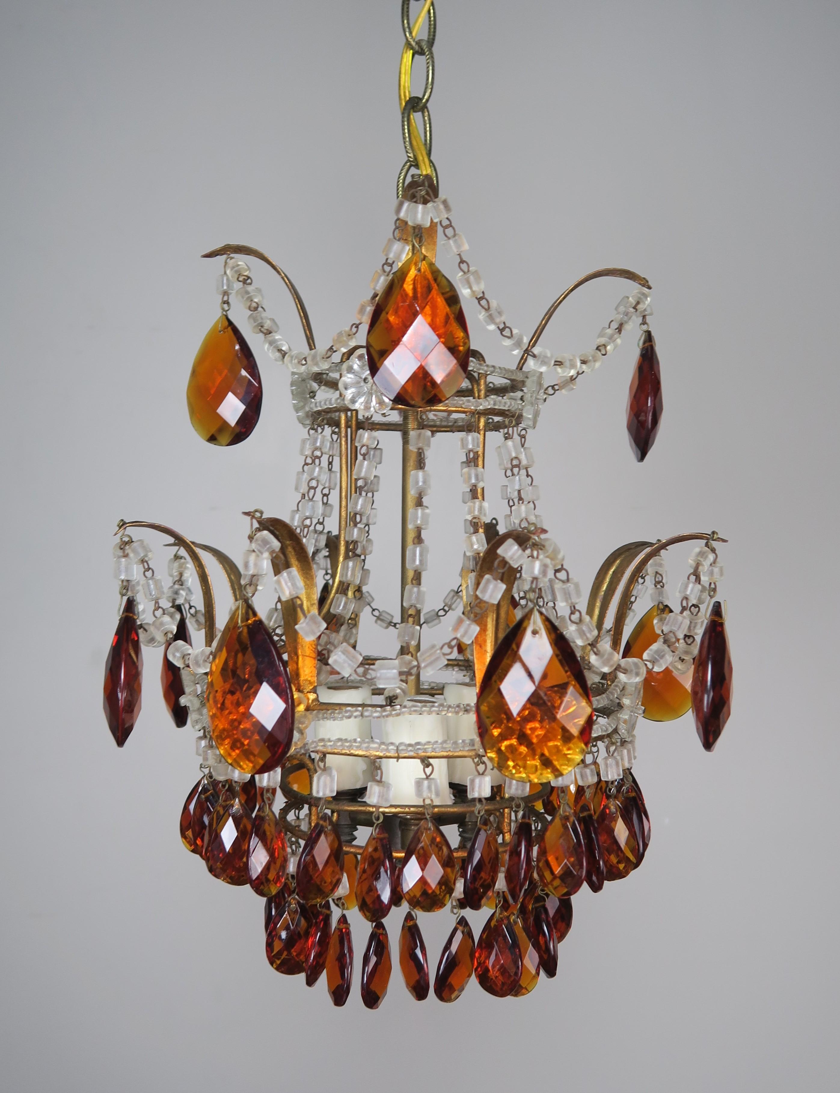 Petite amber crystal macaroni beaded chandelier. This fixture is newly rewired and ready to install. Includes chain and canopy.