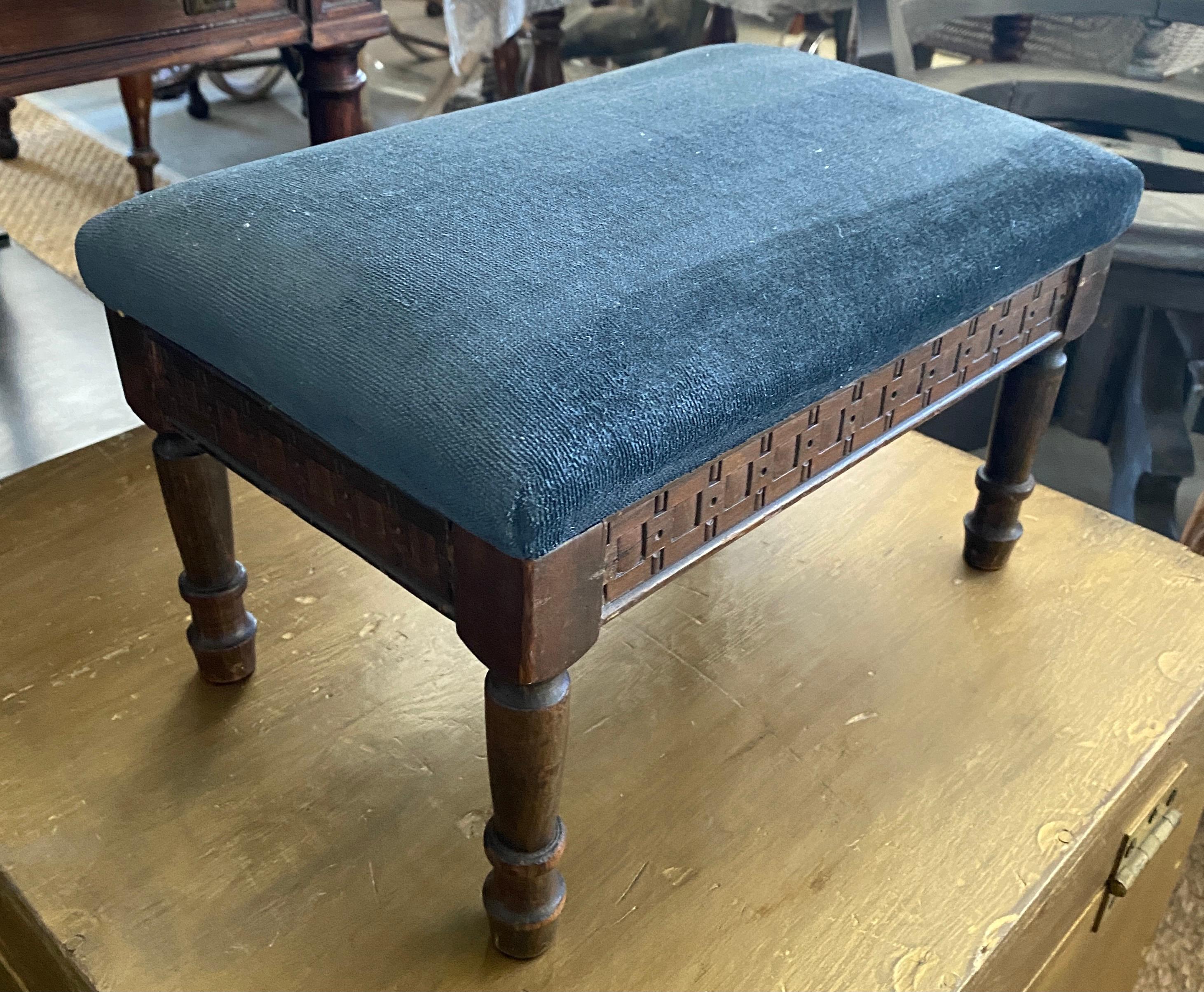 A very charming small antique Louis XV style low blue upholstered carved wood tabouret or foot stool. The stool is covered in a blue canvas like fabric with a velvet look.