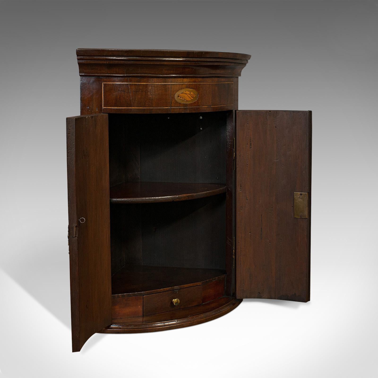 This is a petite antique corner cabinet. An English, mahogany Georgian revival cupboard, dating to the Victorian period, circa 1880.

Diminutive, yet wonderfully presented
Displays a desirable aged patina
Select mahogany shows fine grain