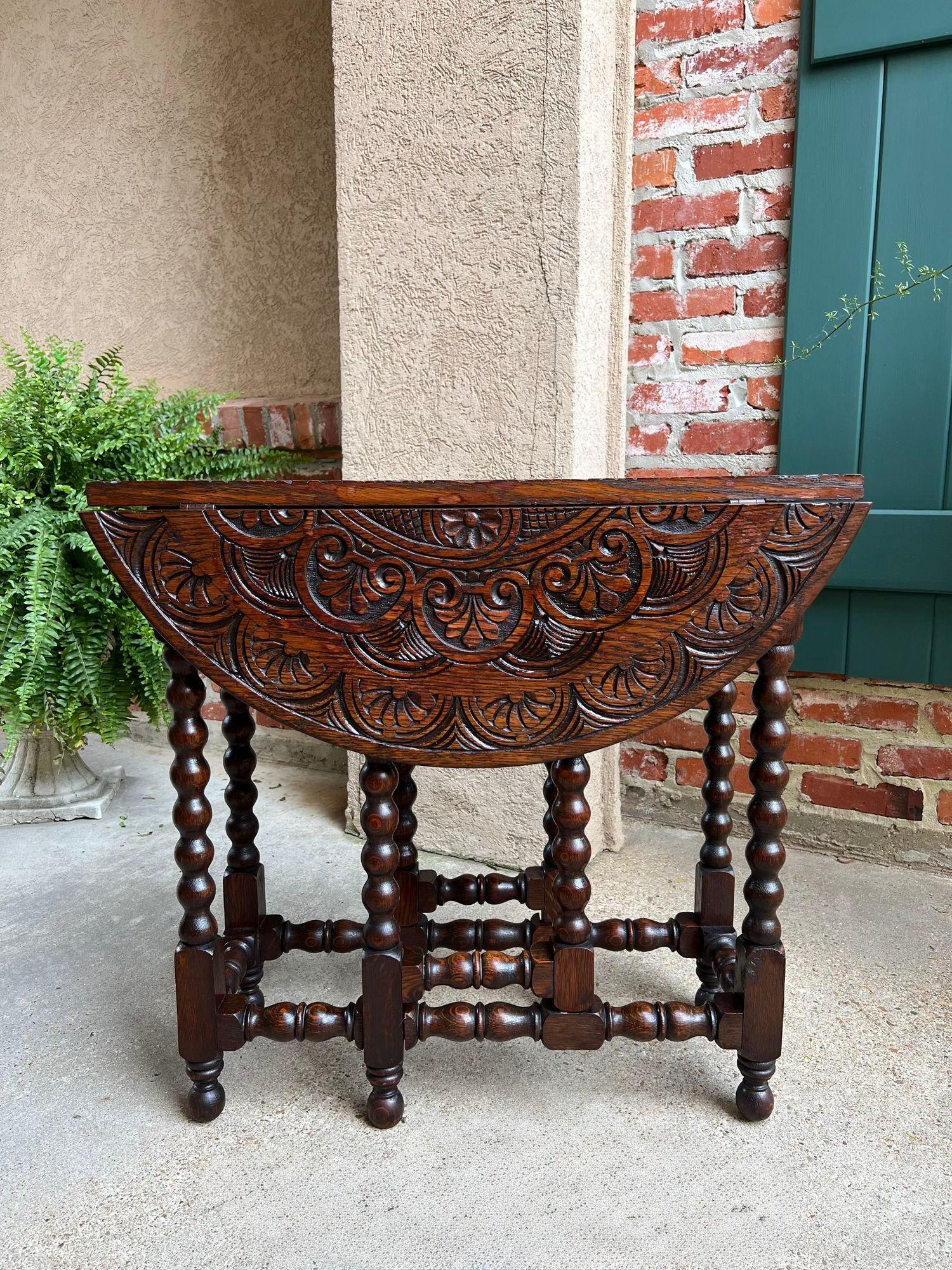 Petite Antique English Drop Leaf Side Sofa Table Carved Oak Round top c1920.

Direct from England, a beautiful little antique English gate leg, drop leaf table with British bobbin legs on the table AND on the gate legs!
The ROUND table top is FULLY