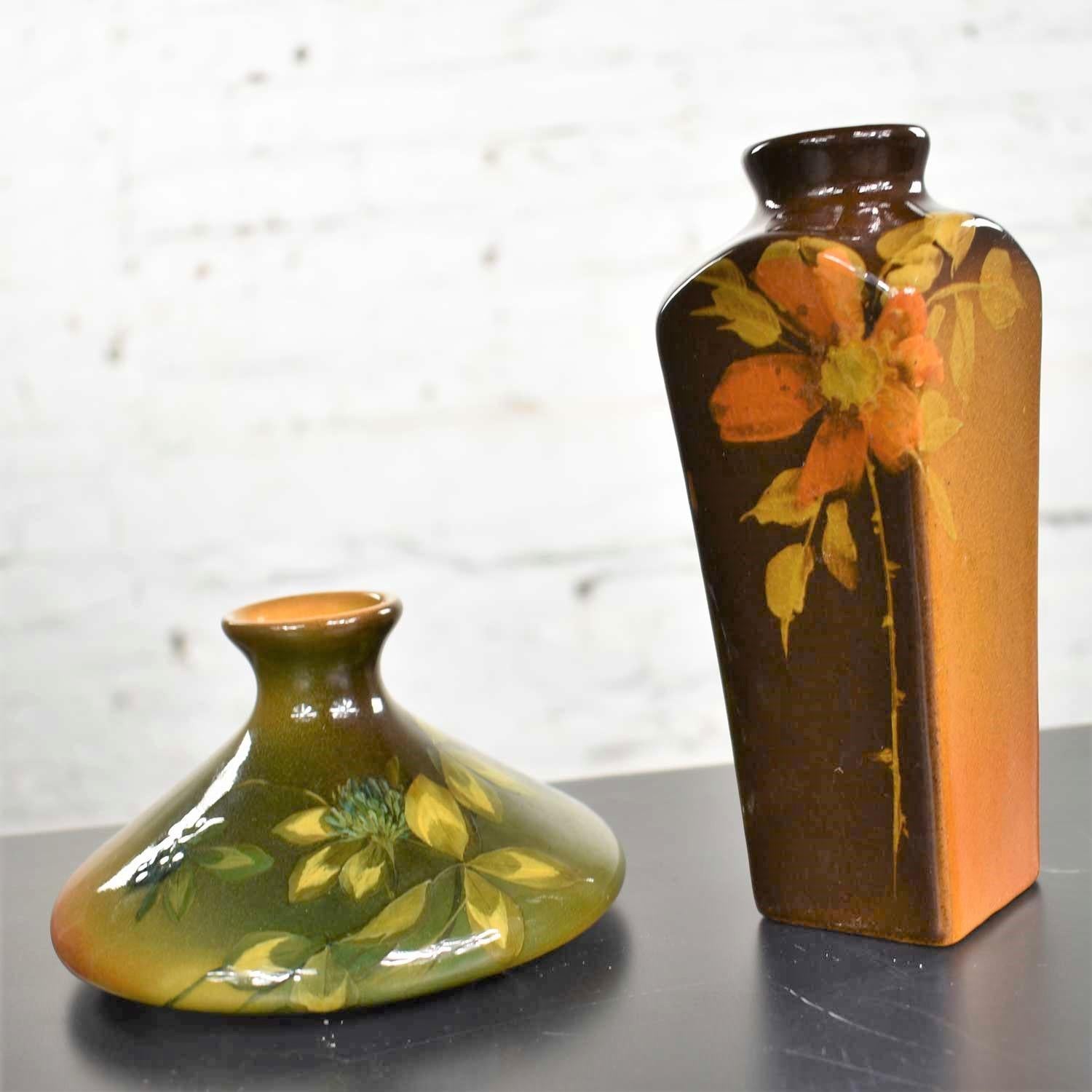 Handsome pair of petite antique Arts & Crafts floral pattern vases. One vase by Olga Geneva Reed for Rookwood Pottery and one J.B. Owens Pottery vase. Both with floral decoration. They are both in excellent vintage condition. No chips, cracks,