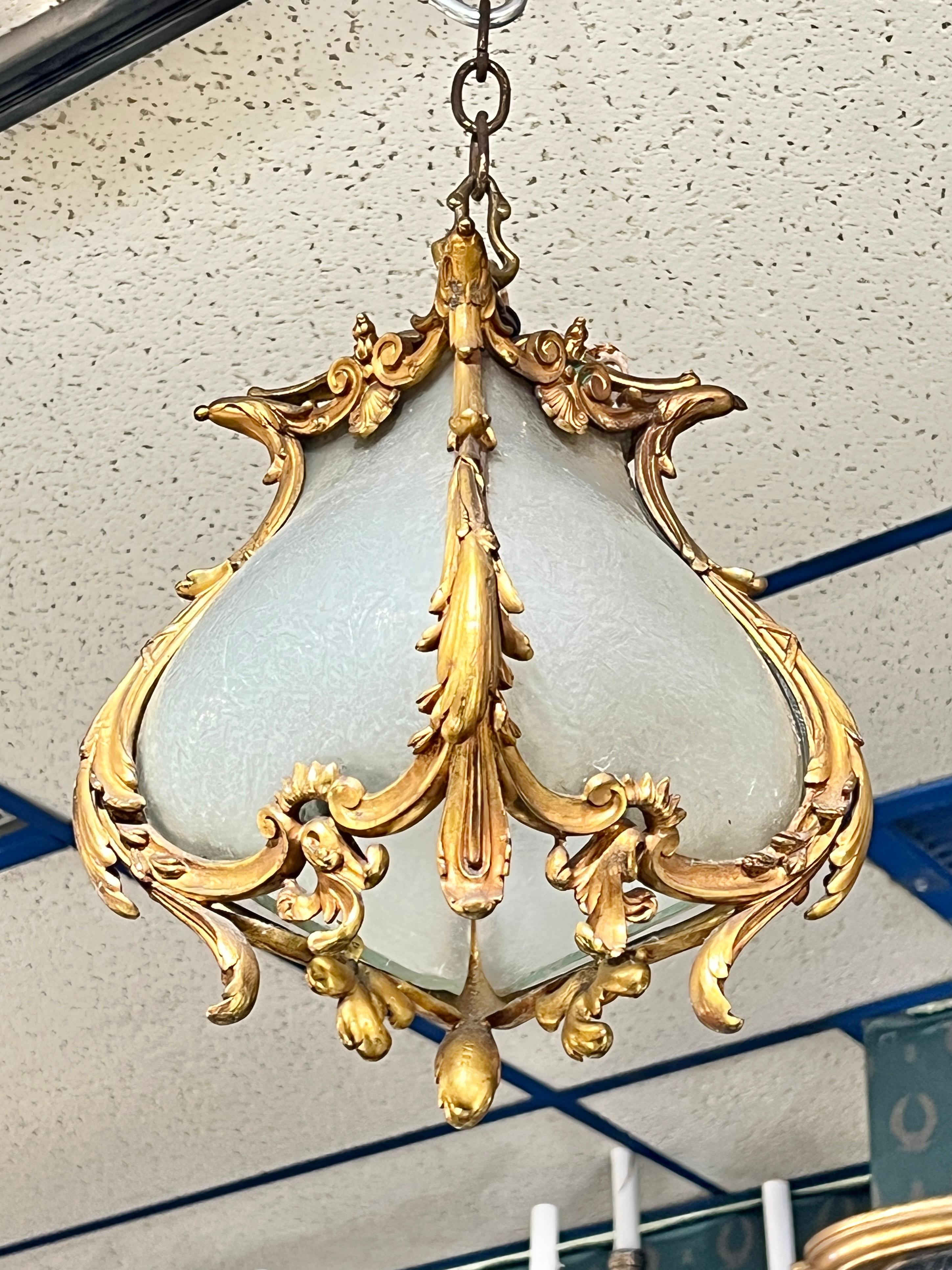 Petite antique gilt bronze lantern with frosted glass panels measuring 7.5 inches wide and deep and approximately 14 inches tall.