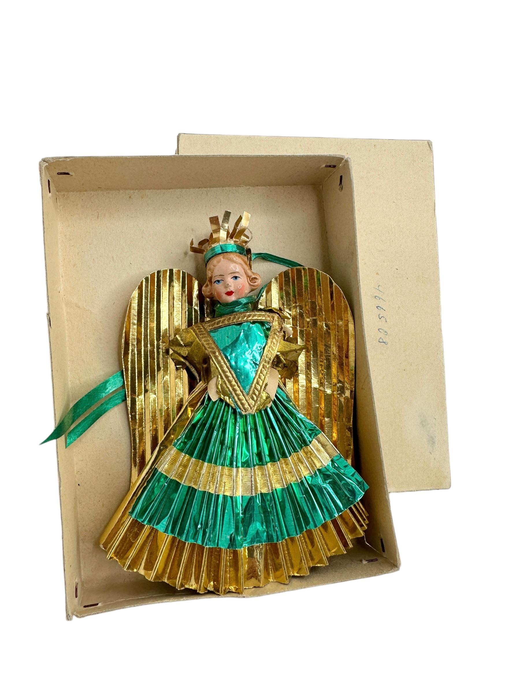 A rare feather tree Christmas tree topper. It is hand made from gold foil, paper and a composition (mass) head, would be a great antique addition for your Christmas or feather tree. 
It is a Nuremberg Christ kindles Market Angel, a traditional Angel