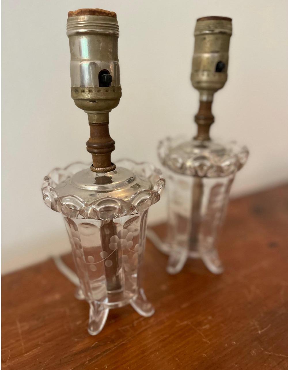 Sweet pair of petite table lamps made from antiqued glass. Details include etched florals and scalloped top. Pair these with sweet shades of your chairs. Working condition.

