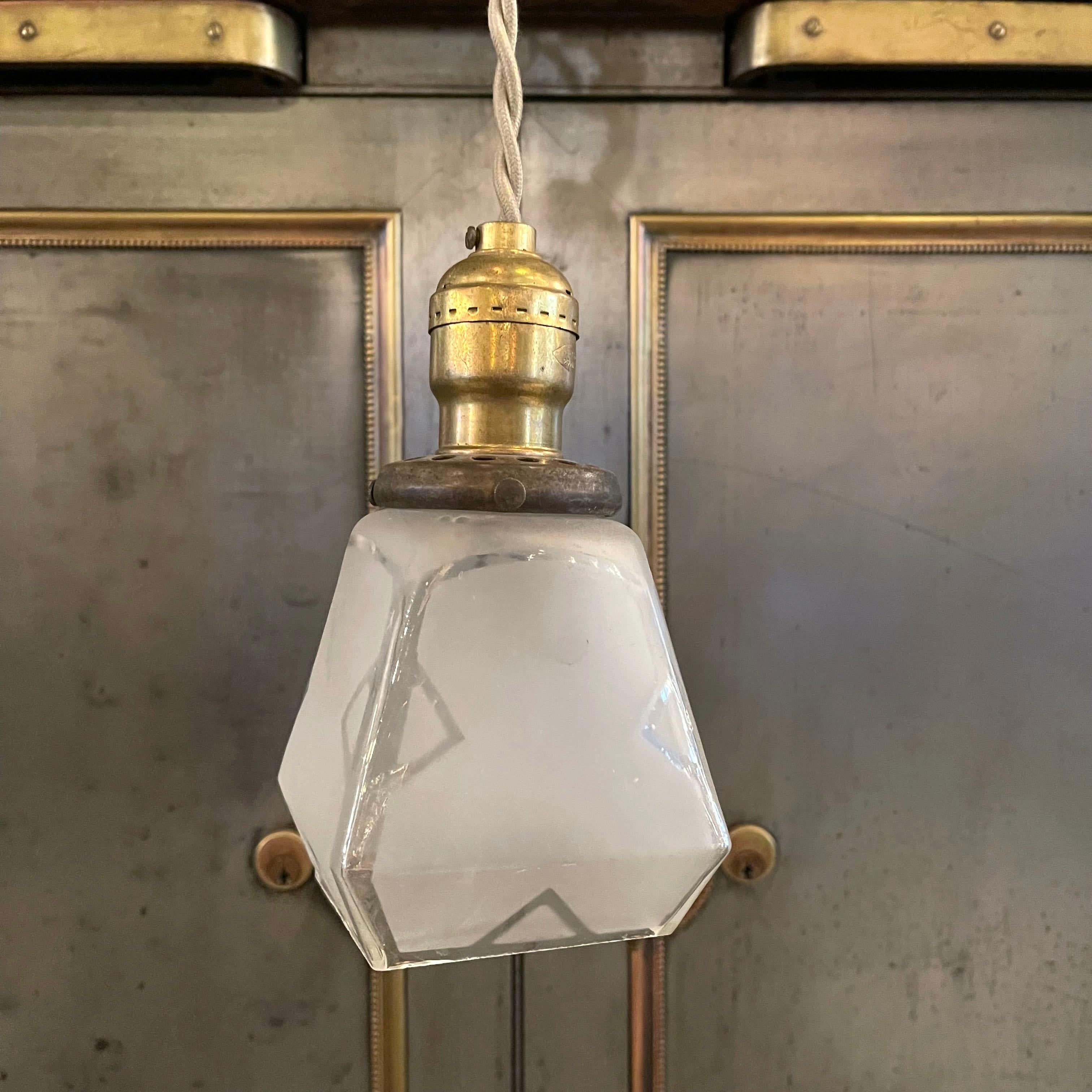 Petite, arts and crafts, pendant light with faceted, clear and frosted glass shade and brass pull chain hardware is newly wired with beige barided cloth cord to hang at 77 inches overall length.