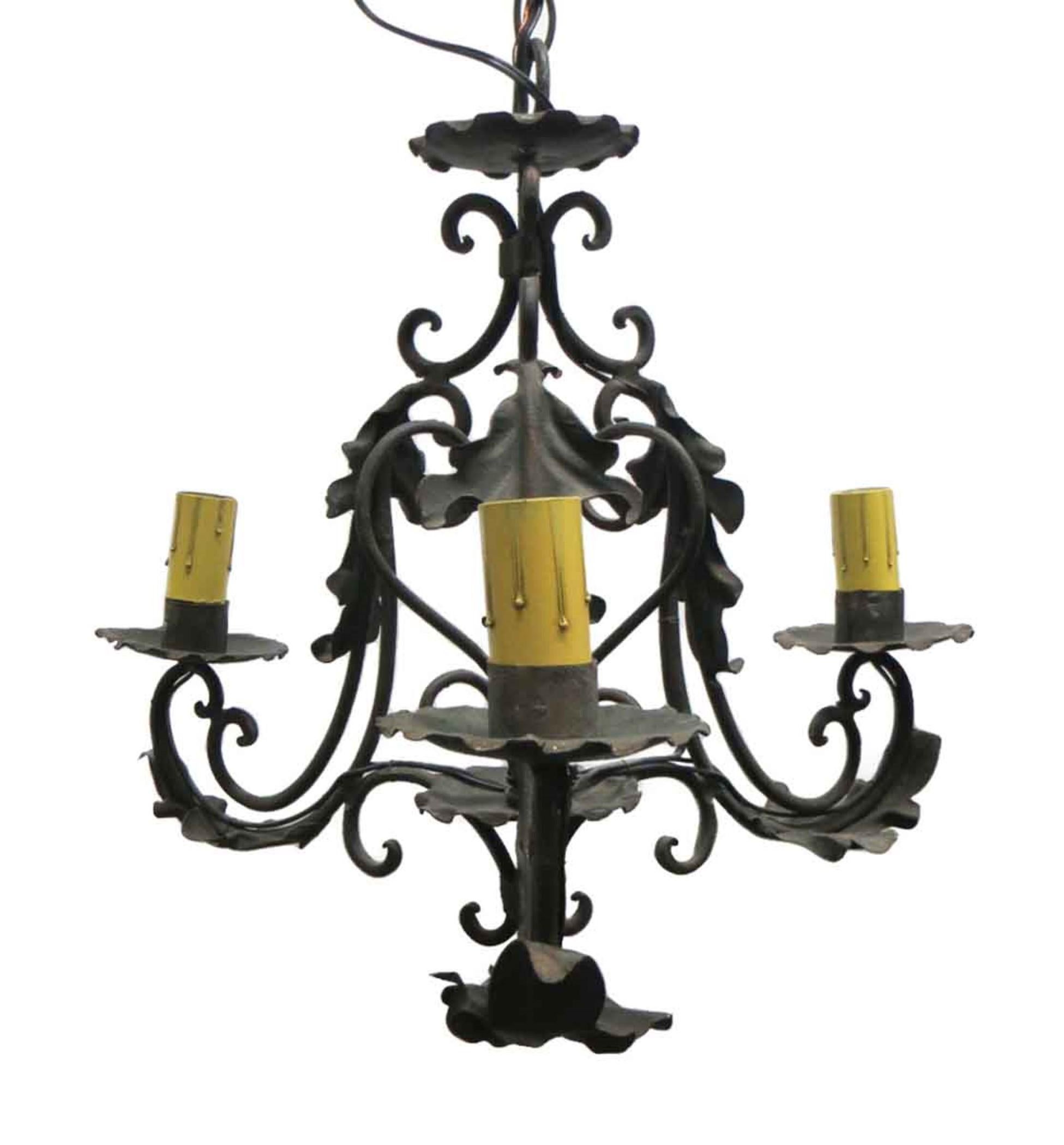 Arts & Crafts style steel and iron three candlestick arm chandelier with scroll and leaf motifs and a blackened finish. This is completely wired with the canopy. This can be seen at our 400 Gilligan St location in Scranton, PA.