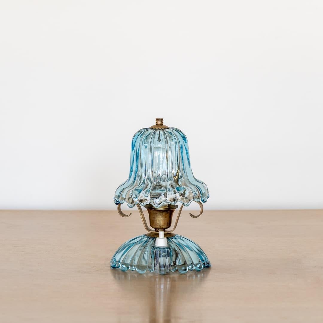 Petite Barovier glass lamp from Italy, 1940's. Striking blue ribbed glass bell shade with wavy rim on a glass base. Push button and new wiring. Beautiful age and patina to the brass. Takes one E14 base bulb, 15 W or higher using LED.
