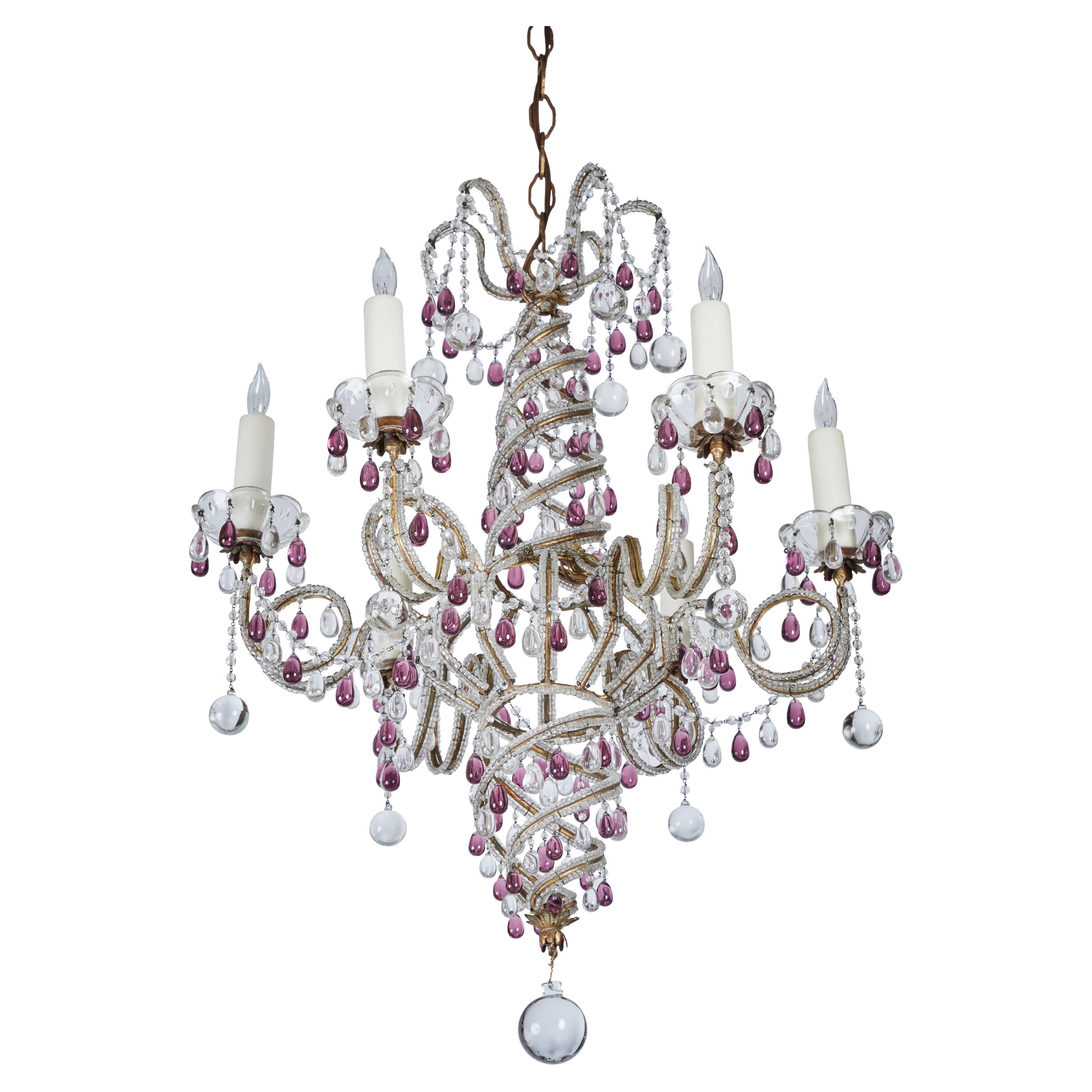 Charming, beaded glass chandelier with amethyst and clear crystal tear drops and spheres. 6 lights. Wired for U.S.

Measures: 46.5”H with adjustable chain and canopy. Chandelier only 28