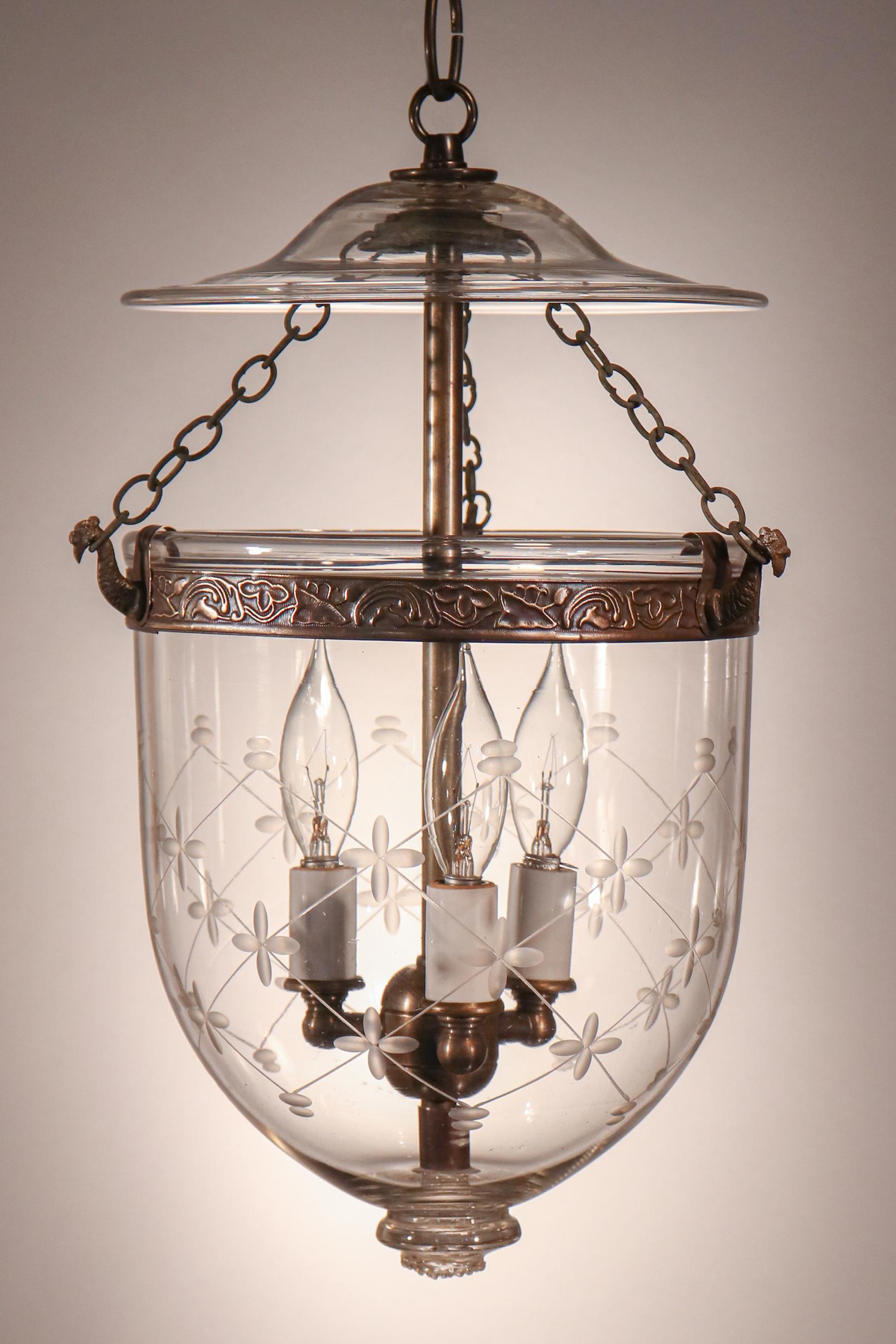 A truly lovely antique English bell jar lantern with fine quality hand blown glass and an etched trellis motif, circa 1890. Perfect for smaller spaces and/or lower ceiling heights, this lantern features its original smoke bell/lid and brass chains.