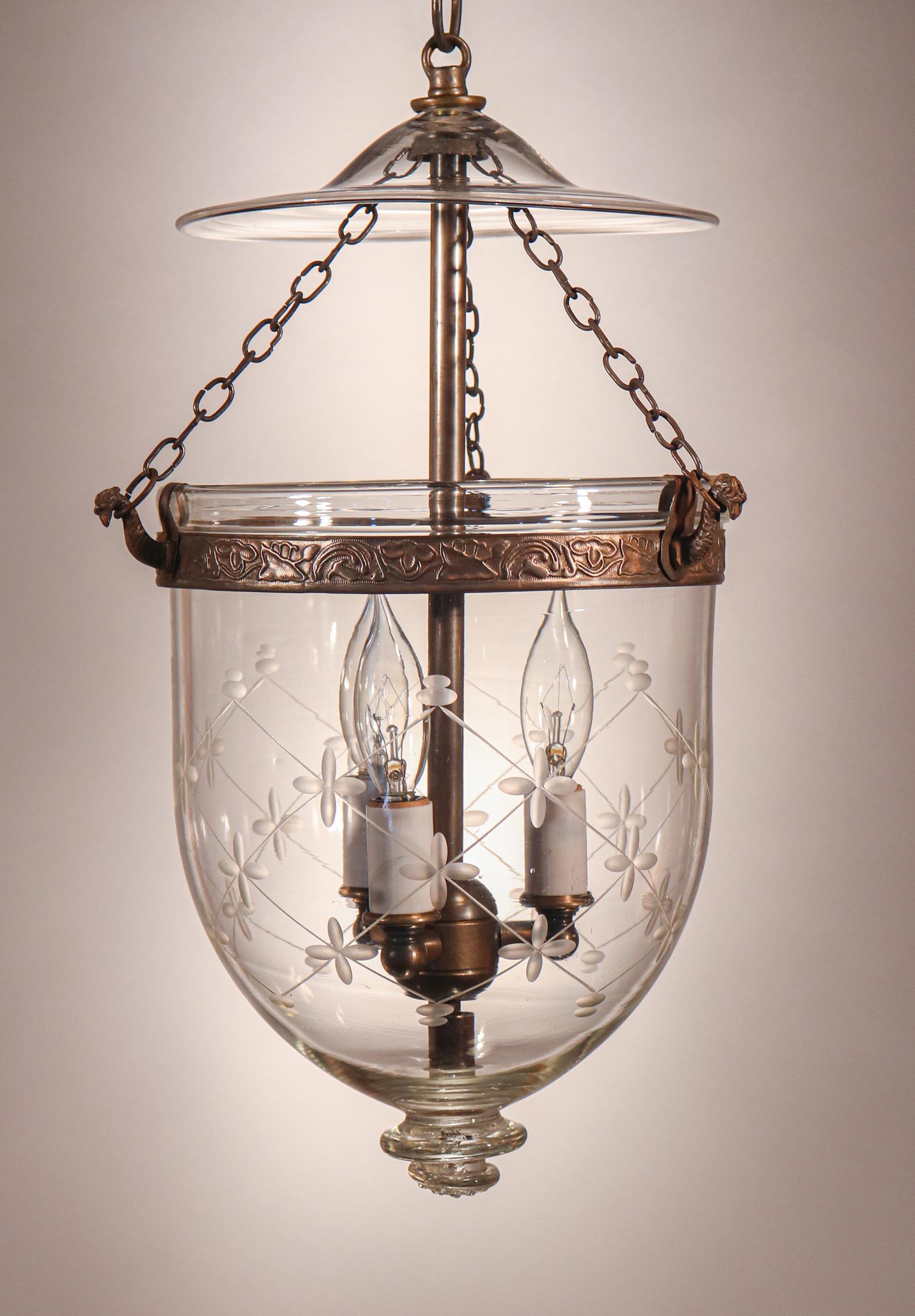 A lovely antique English bell jar lantern with fine quality hand blown glass having an etched trellis motif, circa 1880. Perfect for smaller spaces and/or lower ceiling heights, this lantern features its original smoke bell/lid. The brass band,