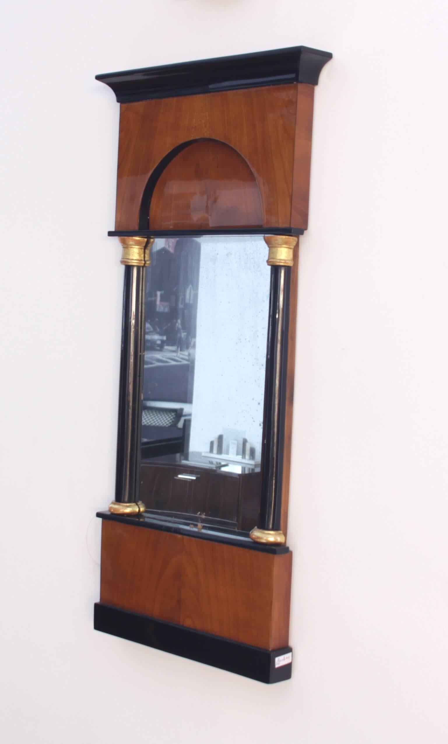 Wonderful petite early Biedermeier mirror from South Germany about 1820

Wood: Book-matched cherry veneer, French polished
Half columns, gold-plated capitels and bases
Segmental arch, partly ebonized.

Old mirror glass.