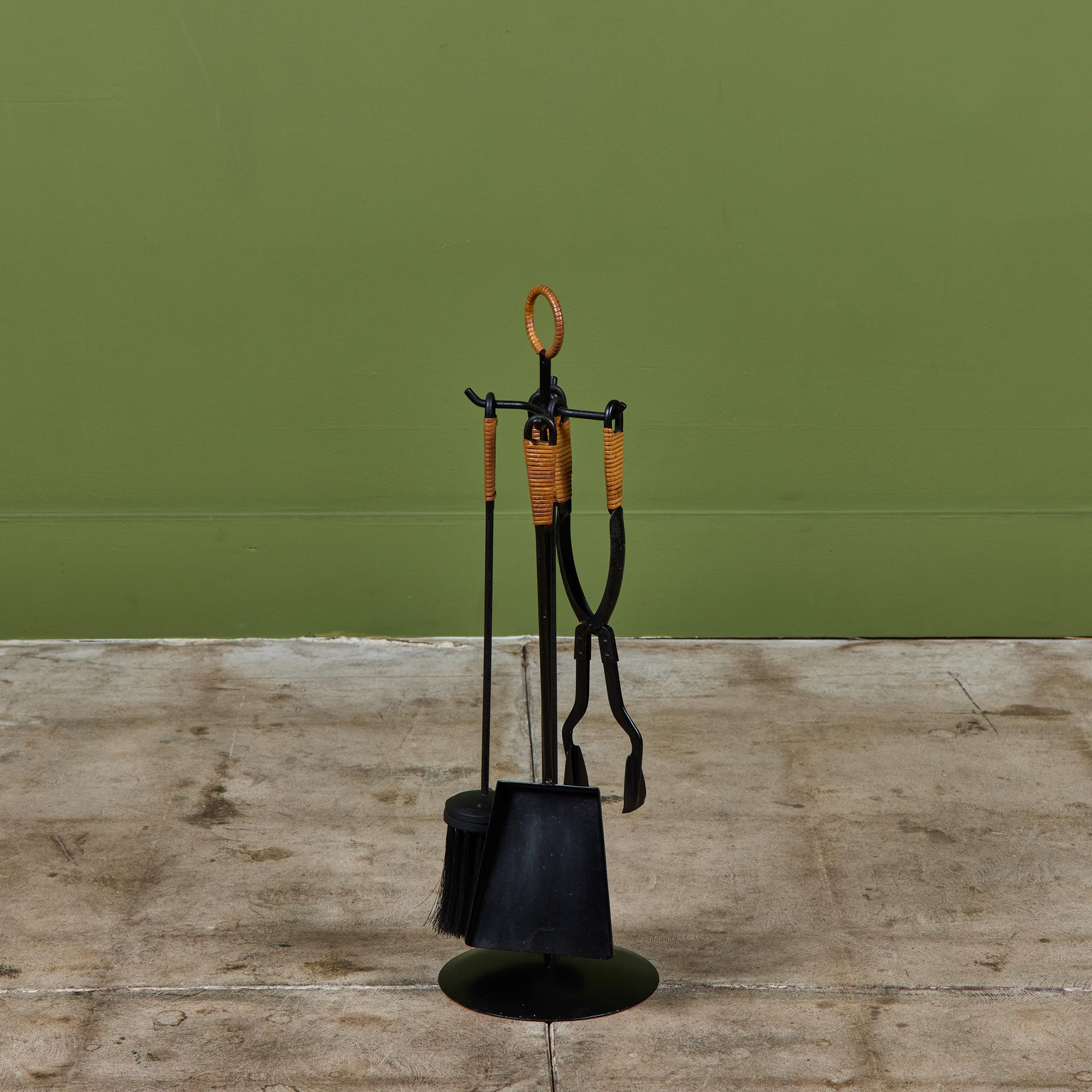 Five piece set of fireplace tools with stand. The set features five tools with cylindrical blackened steel base. All elements have cane wrapped handles.

Dimensions
7.5