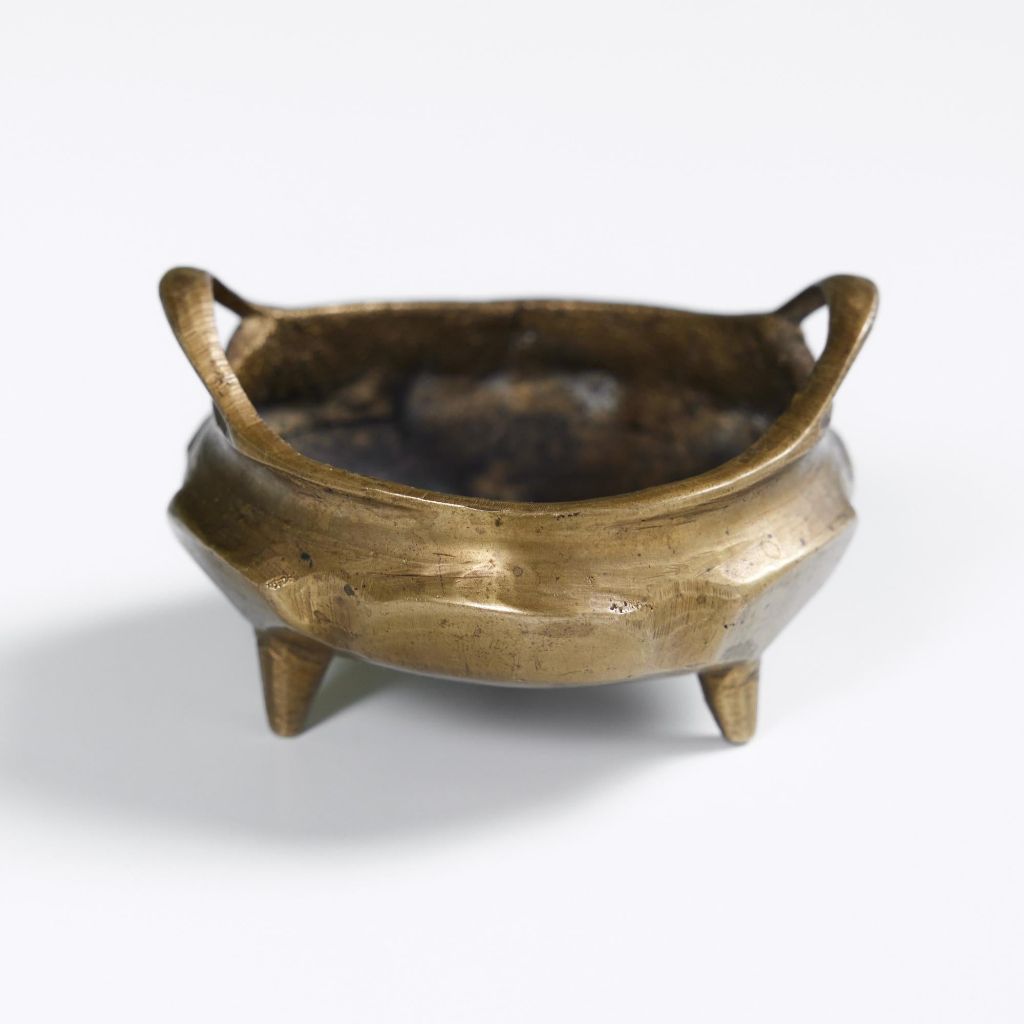 Petite brass bowl that could be used to hold a myriad of trinkets within its curved walls. The dish is finished with two rounded handles and rests on three legs. We personally love it for burning incense cones.

Dimensions
2.5