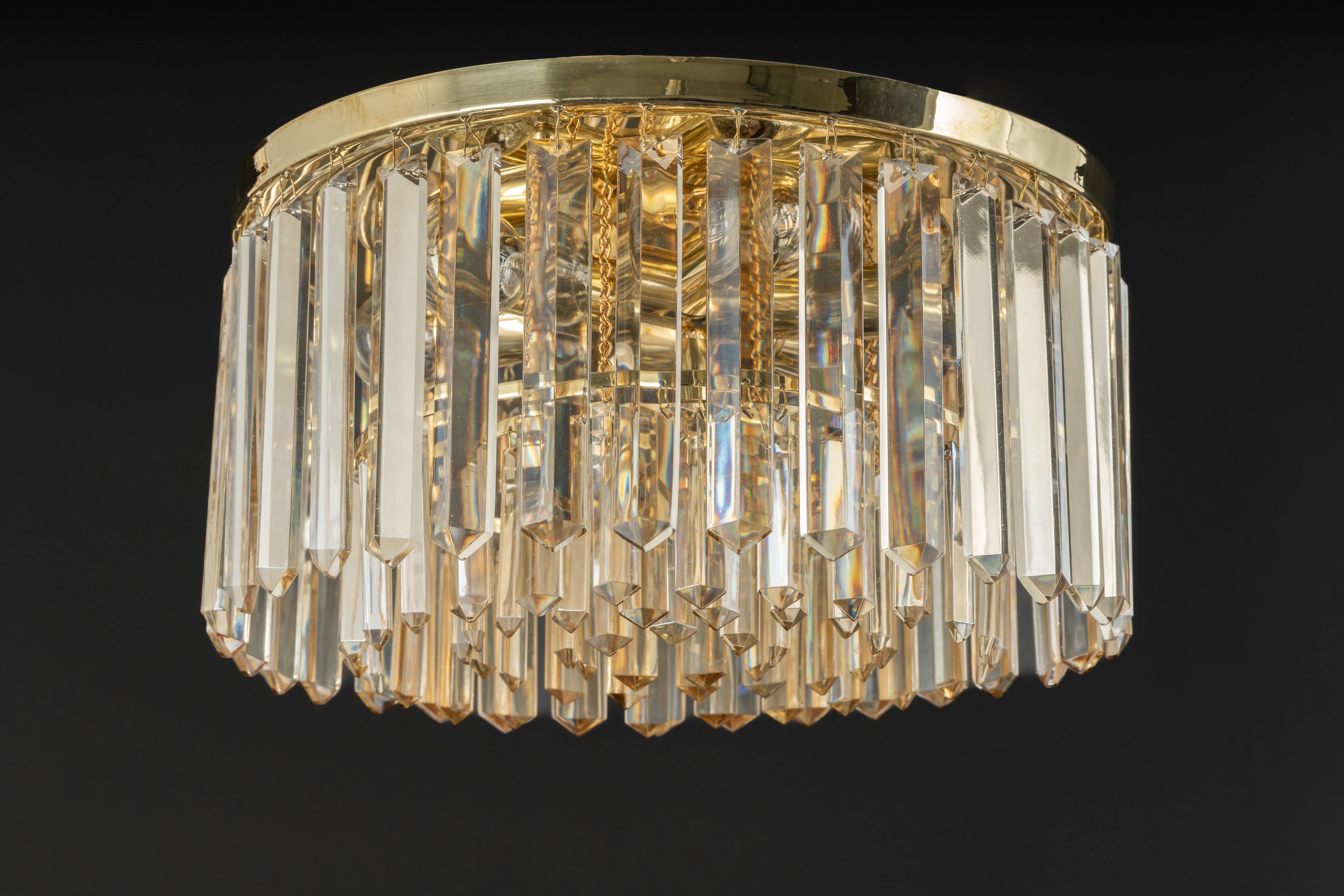 A wonderful petite flush mount light fixture by Palwa, Germany, 1970s.
It is made of a brass frame decorated with large size of crystals. Wonderful light effect.

The lamp takes 7 x E14 (Small Bulbs up to 40 Watts each)
Light bulbs are not