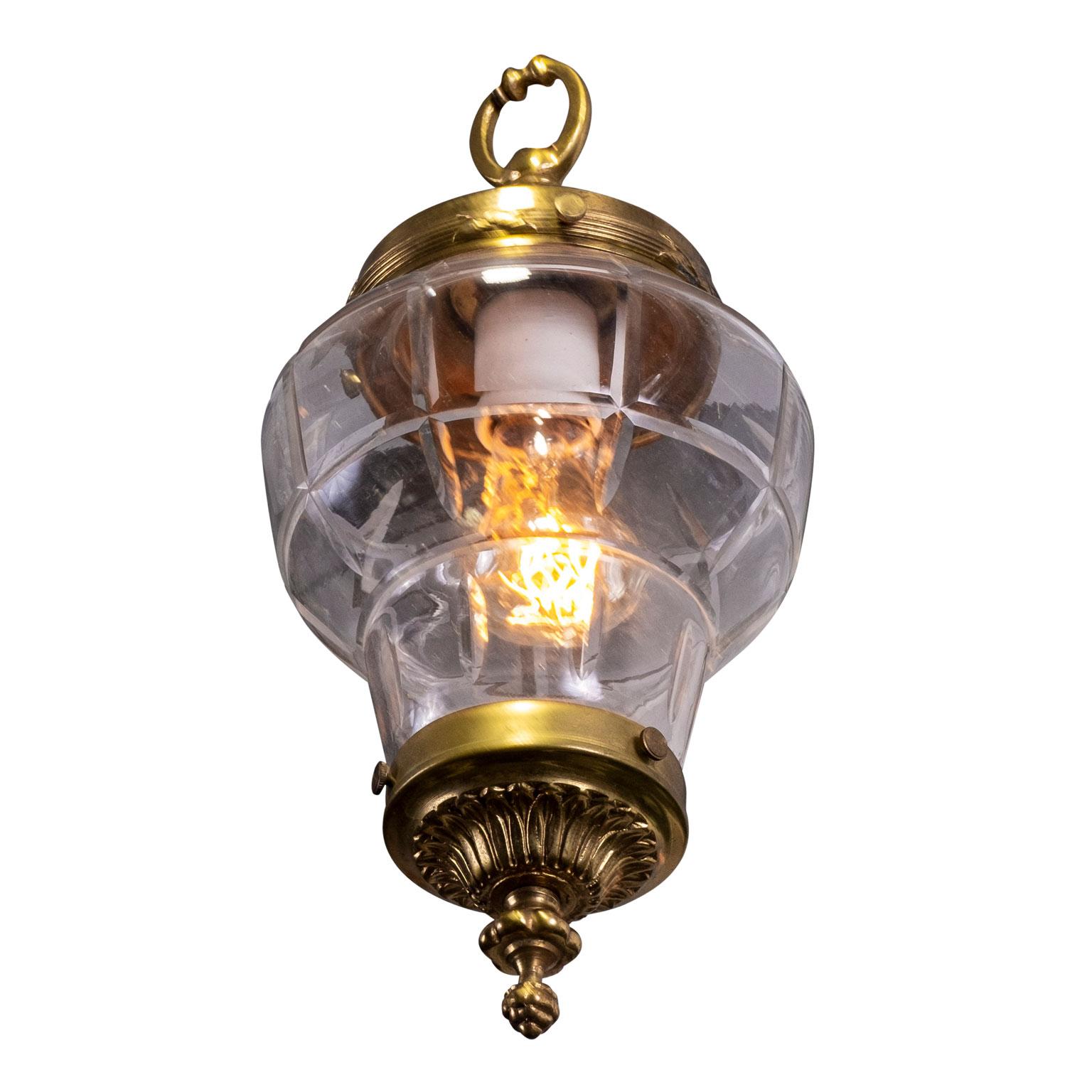 Petite antique brass French hall lantern, circa 1910-1940. Brass pendant with hand blown glass shade. Newly wired for use within the USA using UL listed parts. Includes chain and a canopy (listed height does not include chain). Perfect fixture for