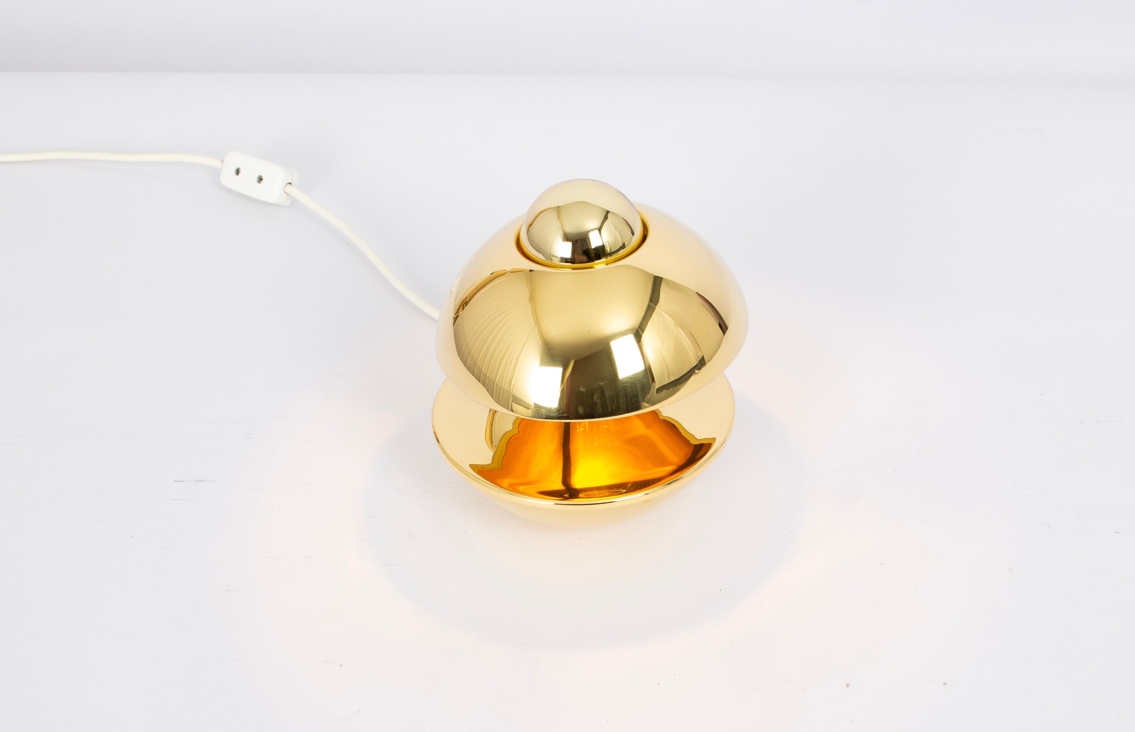 Petite Brass Table lamp made by Kaiser, Germany, 1970s
Designer: Klaus Hempel
Wonderful form and stunning light effect.
This Model won the IF Product Design Award 1972
Sockets: 1 x E14 small bulbs. (40 W max each).
Light bulbs are not included. It