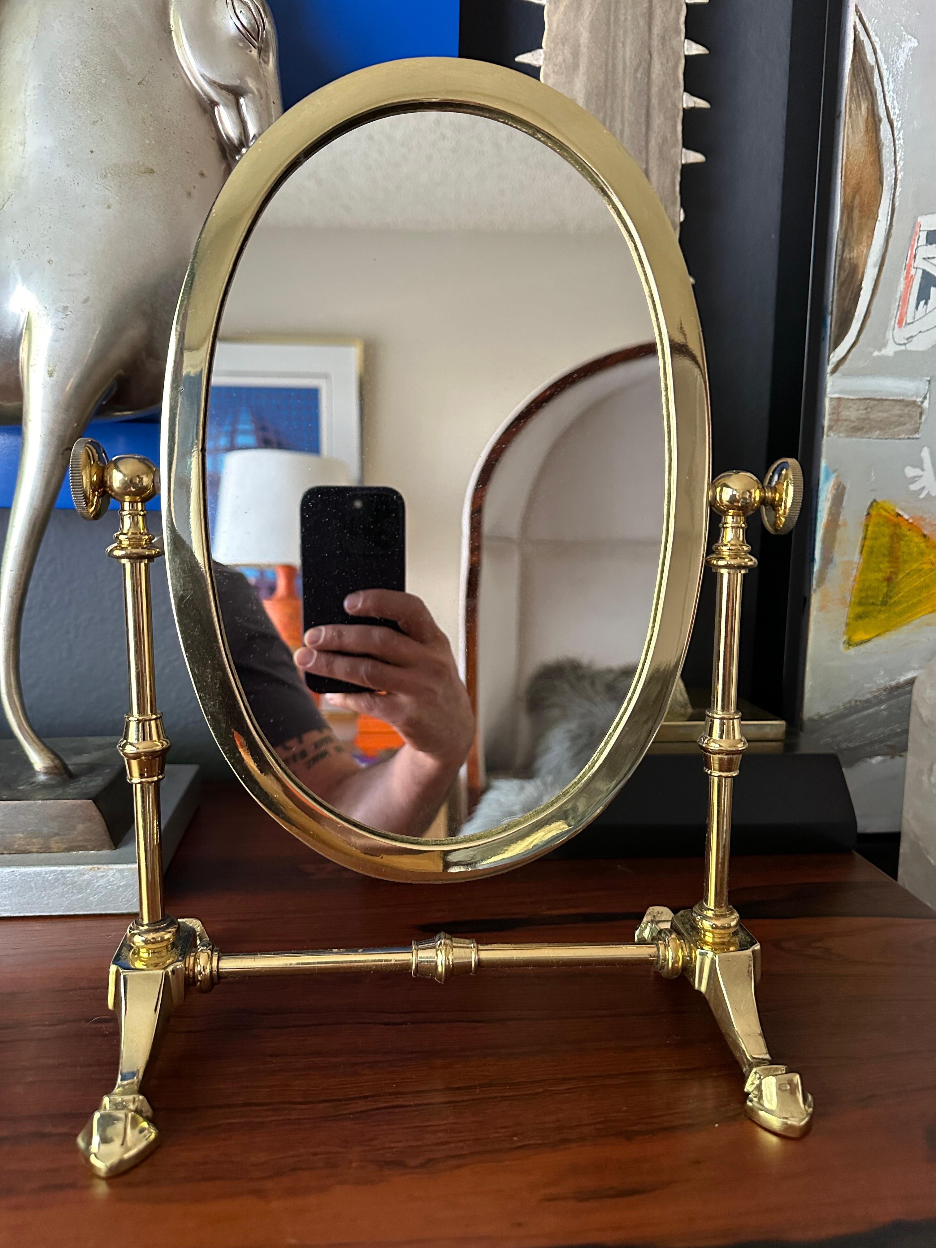 Petite brass vanity mirror in the style of Charles Hollis Jones.
Only oval mirror is 7