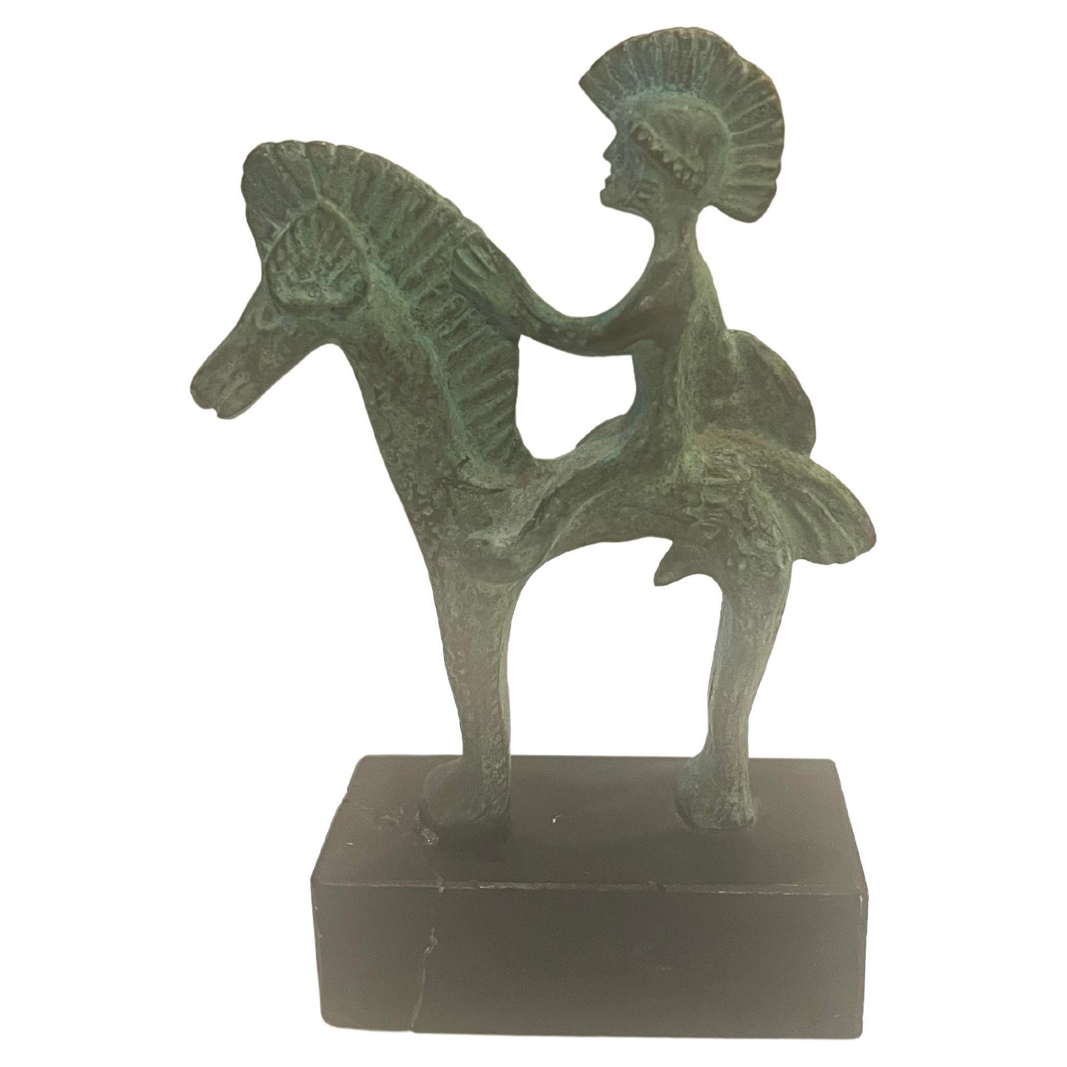A small Etruscan bronze statue circa the 1970s made in Italy mounted in a black stone base the base shows a crack and repair it can easily be replaced or leave it as is, the bronze sculpture is perfect.