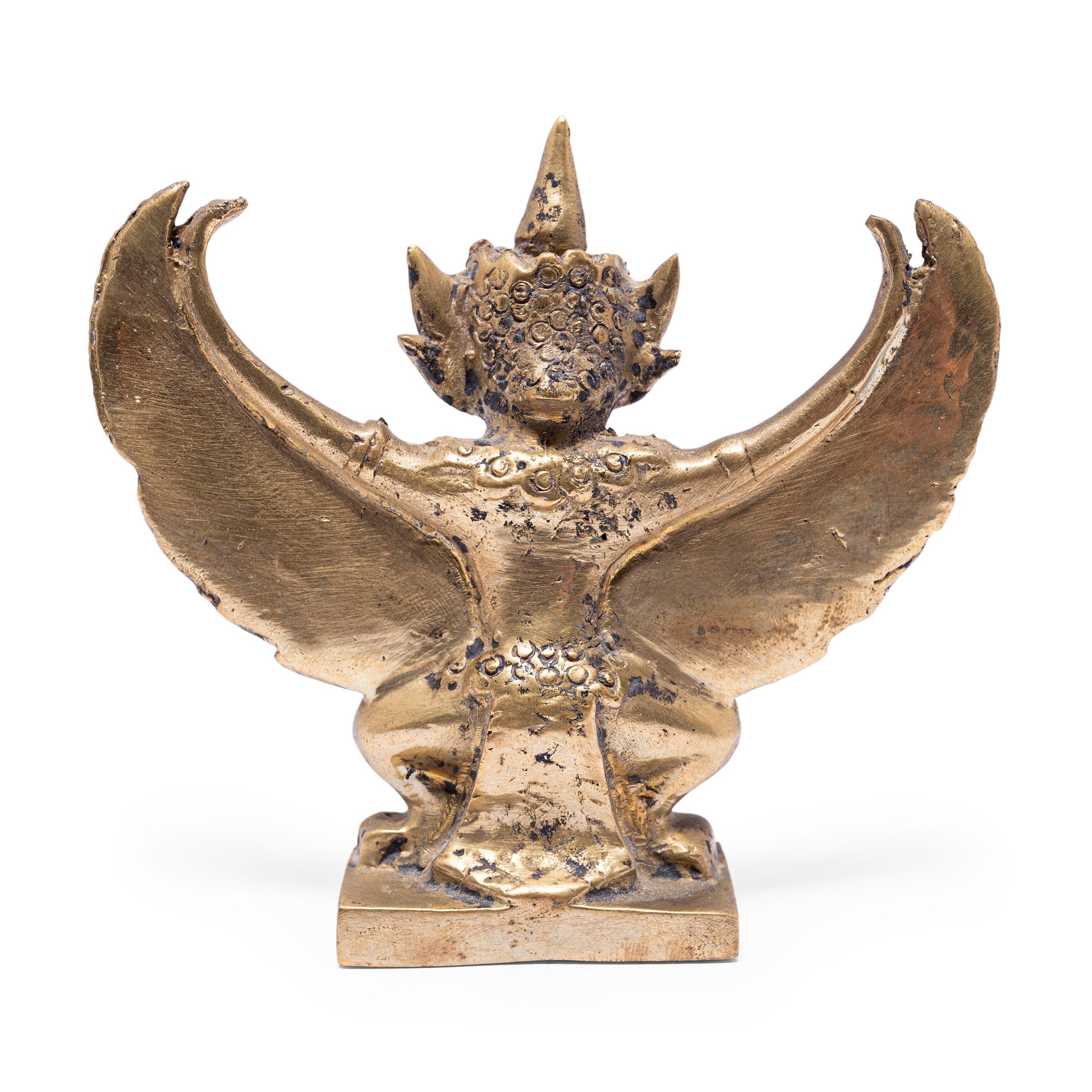 Cette petite figurine en bronze est coulée sous la forme de Garuda, demi-dieu et roi mythique des oiseaux dans la foi hindoue et bouddhiste. Prenant la forme mi-oiseau mi-homme, Garuda est un puissant protecteur et un ennemi toujours vigilant du