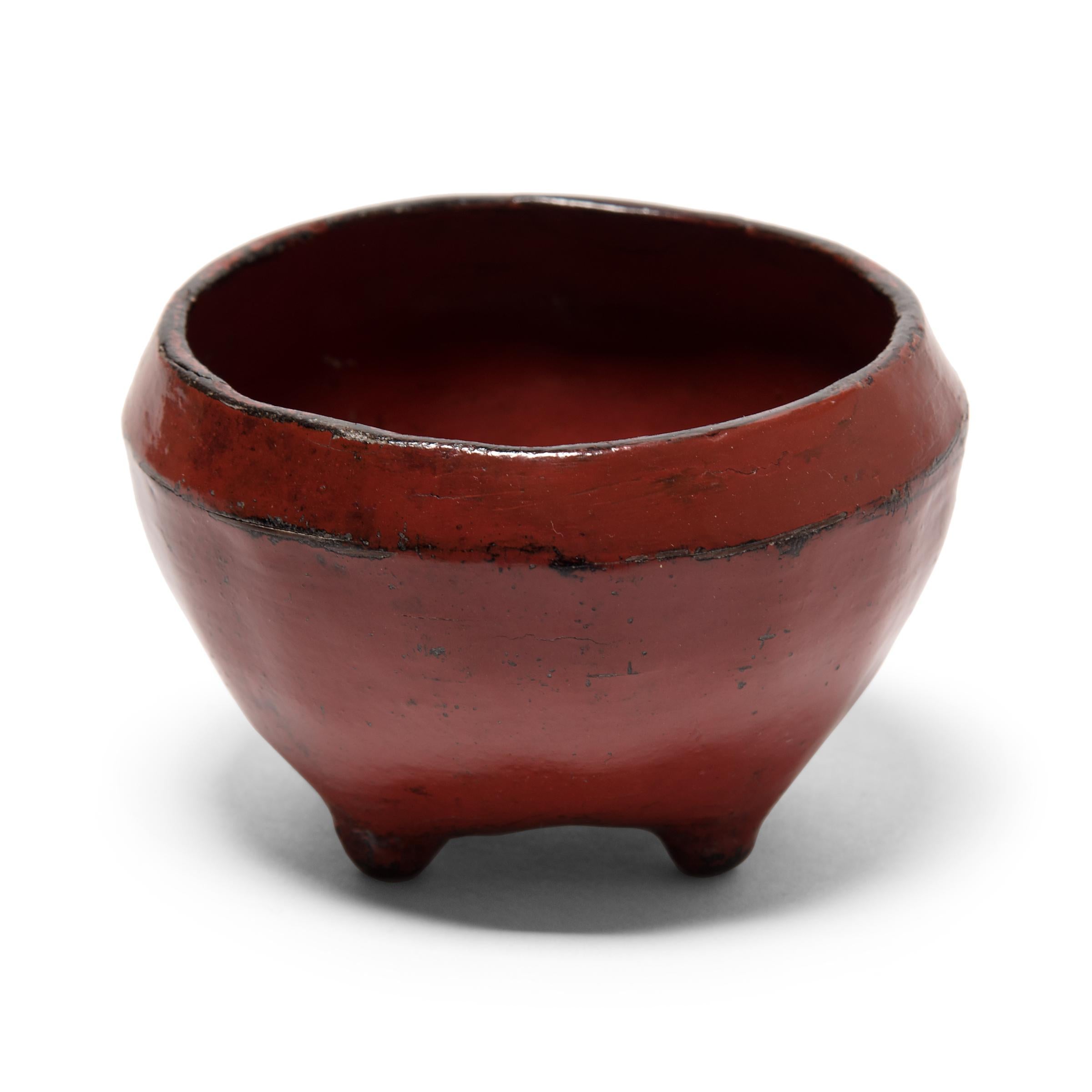 This round footed bowl was made by coating a thin core structure of wood and clay with bright red cinnabar lacquer. The remarkably lightweight vessel has a richly aged finish and adds a wonderful pop of red to any interior.