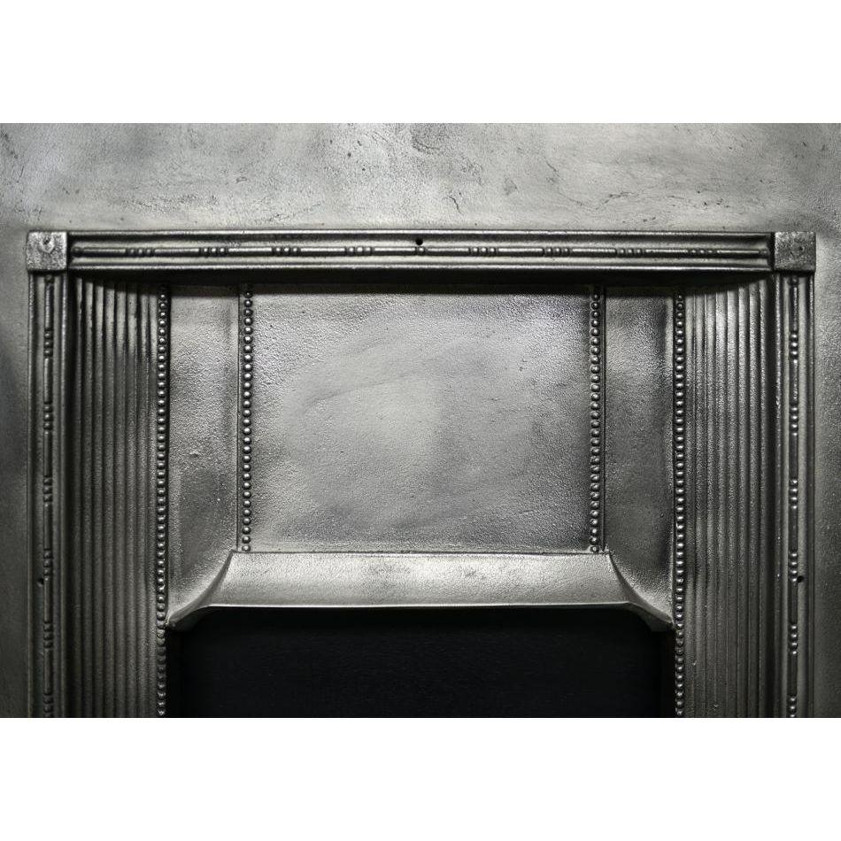 A petite cast iron fireplace. The jambs with vertical reeding and beading detail, with moulded shelf above. English, Edwardian.   

Additional information:
Shelf Width: 725 mm / 28 ½