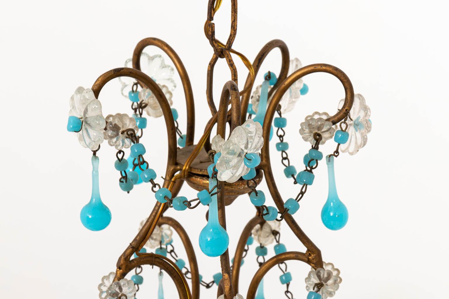 Five-arm unelectrified petite blue and clear crystal chandelier in a gilt finish circa 1970s. Made in France. Please note of wear consistent with age including minor losses. Shades not included.