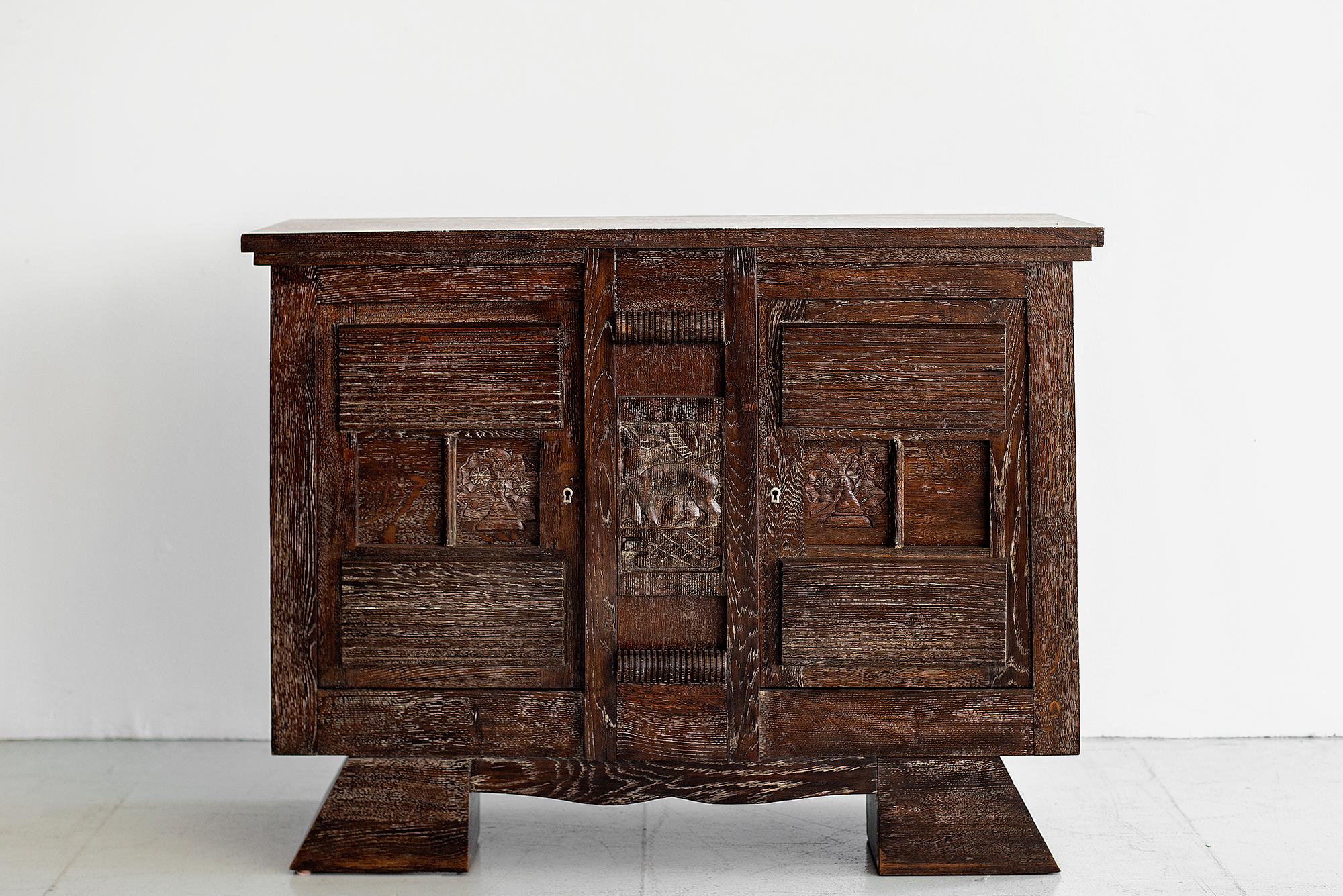 Petite Charles Dudouyt attributed cabinet in dark cerused oak, circa 1940s.
Wonderful lines and hand carved detailing.