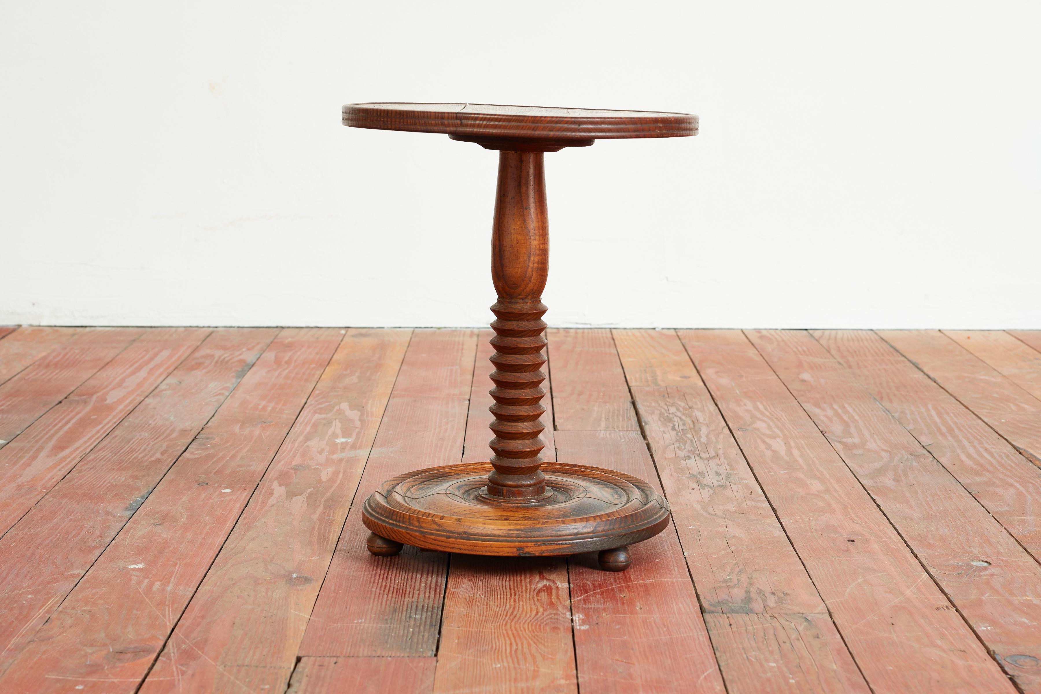 Petite Charles Dudouyt attributed side table with ball feet and irregular shaped corkscrew pedestal. 
Great patina throughout.