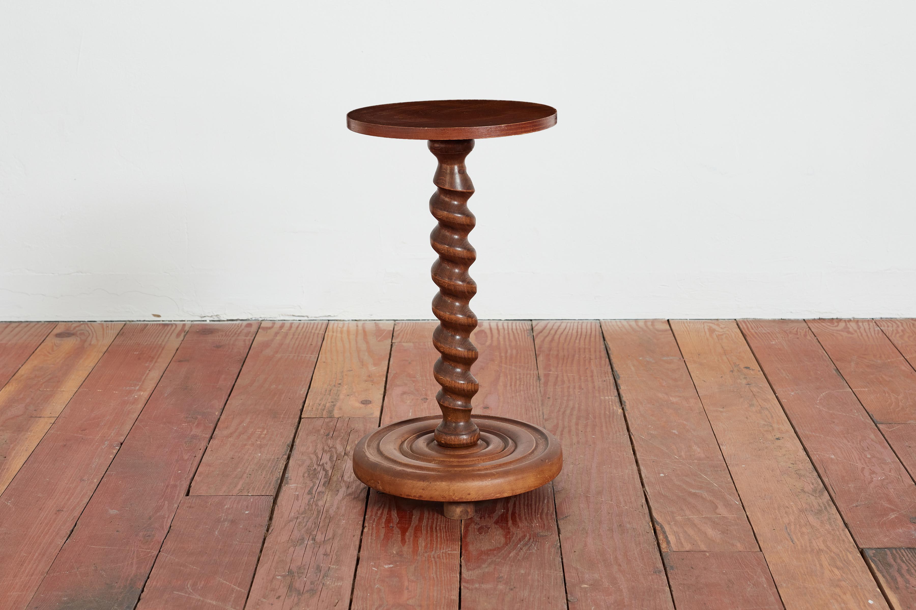 Petite sculptural side table by Charles Dudouyt with wood feet with signature carved corkscrew base. 

Wonderful patina throughout.

