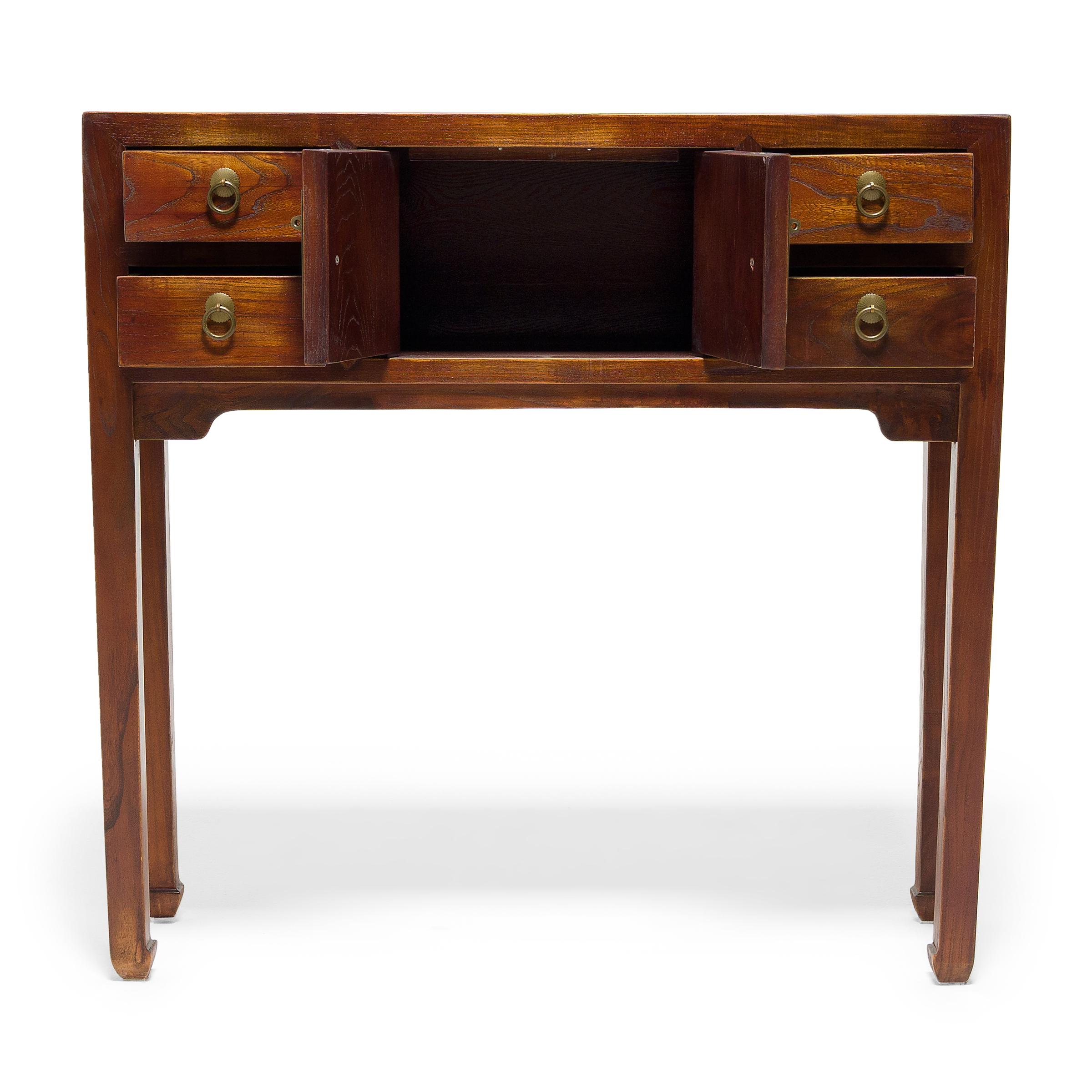 This petite altar coffer keeps with the style of Ming-dynasty furniture with clean lines and minimal ornamentation. The narrow coffer stands on thin legs ending in subtle hoof feet, focusing the eye upwards to its squared frame. The table features