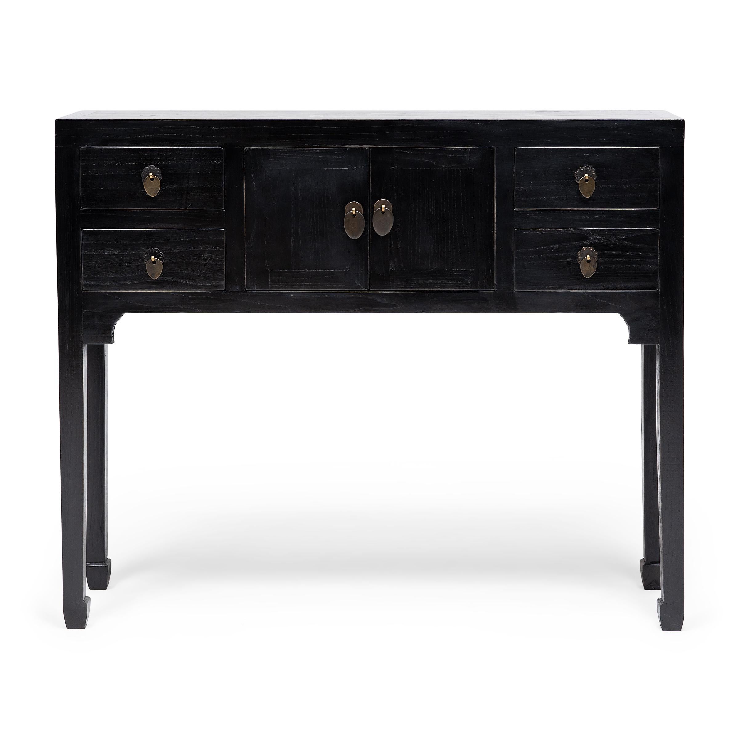 This petite altar coffer keeps with the style of Ming-dynasty furniture through its clean lines and minimal ornamentation. The slim legs and delicate hoof feet bring the eye upwards the squared frame and contribute to the effortless simplicity of