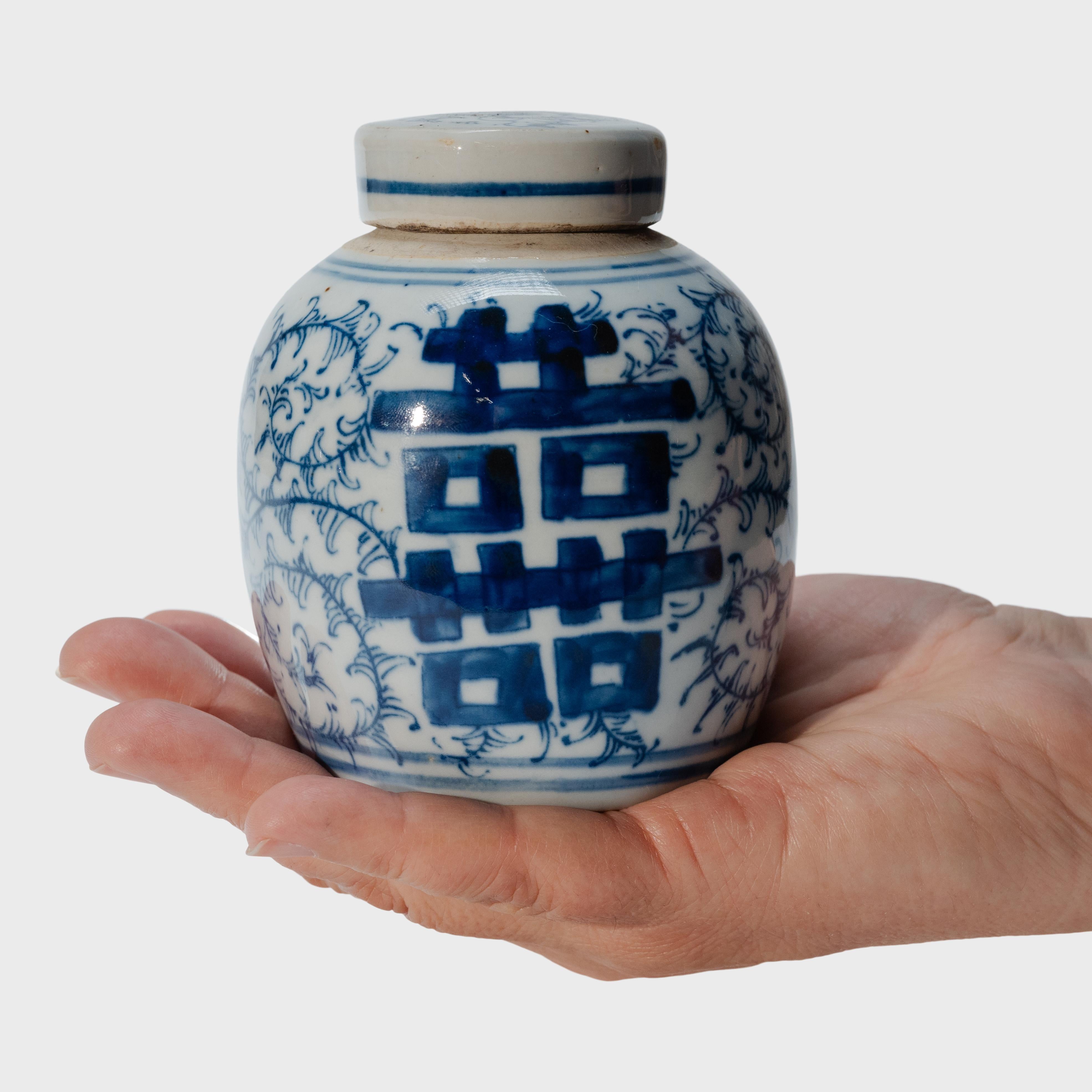 The symbol for double happiness adorns this petite tea leaf jar with best wishes for love, companionship and marital bliss. Glazed in the classic blue and white manner, the small porcelain jar has a rounded form and flat lid, a traditional shape for