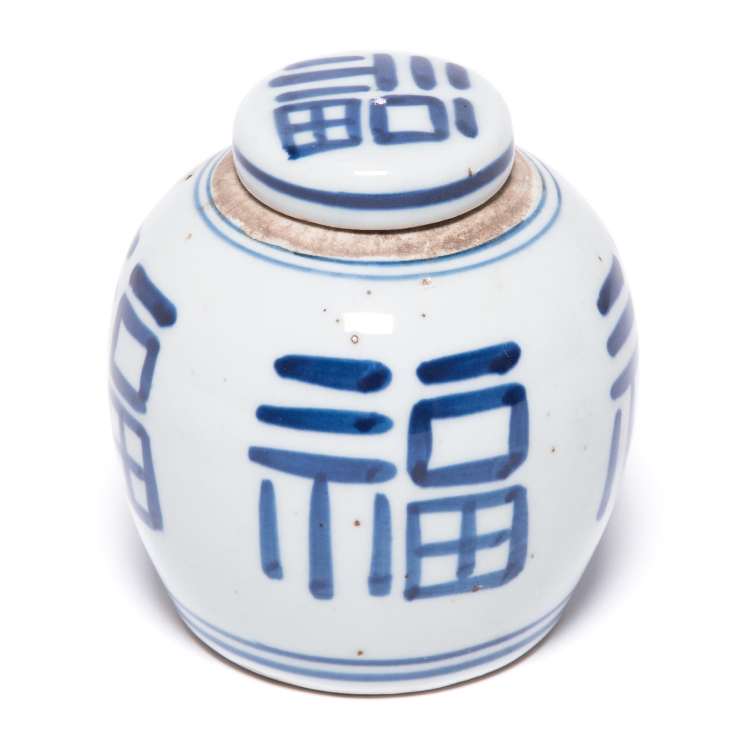 Painted in the classic blue and white manner, this petite ginger jar is marked with an abstracted version of the fu character, a symbol of prosperity and good fortune. Sculpted at the turn of the 20th century, this jar has a clean design and graphic