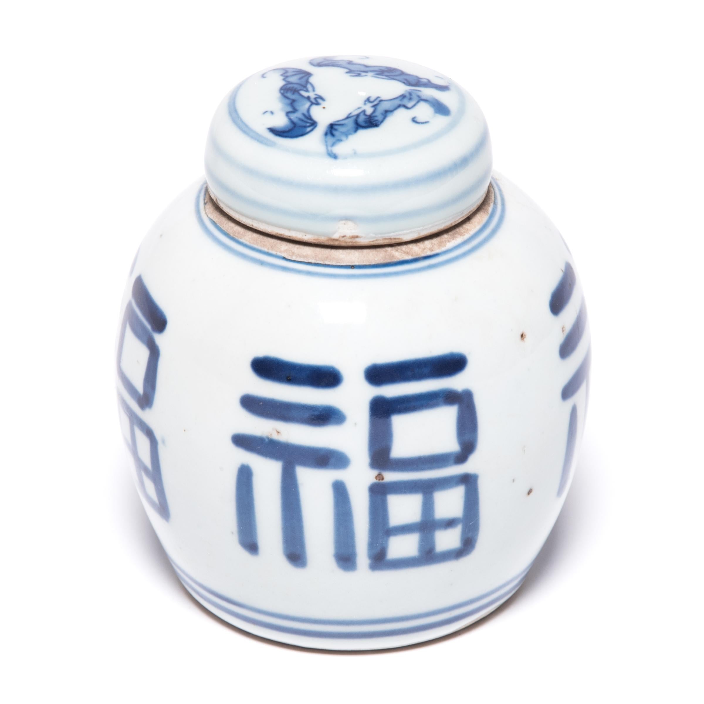 Painted in the Classic blue and white manner, this petite ginger jar is marked with an abstracted version of the Fu character, a symbol of prosperity and good fortune. Sculpted at the turn of the 20th century, this jar has a clean design and graphic