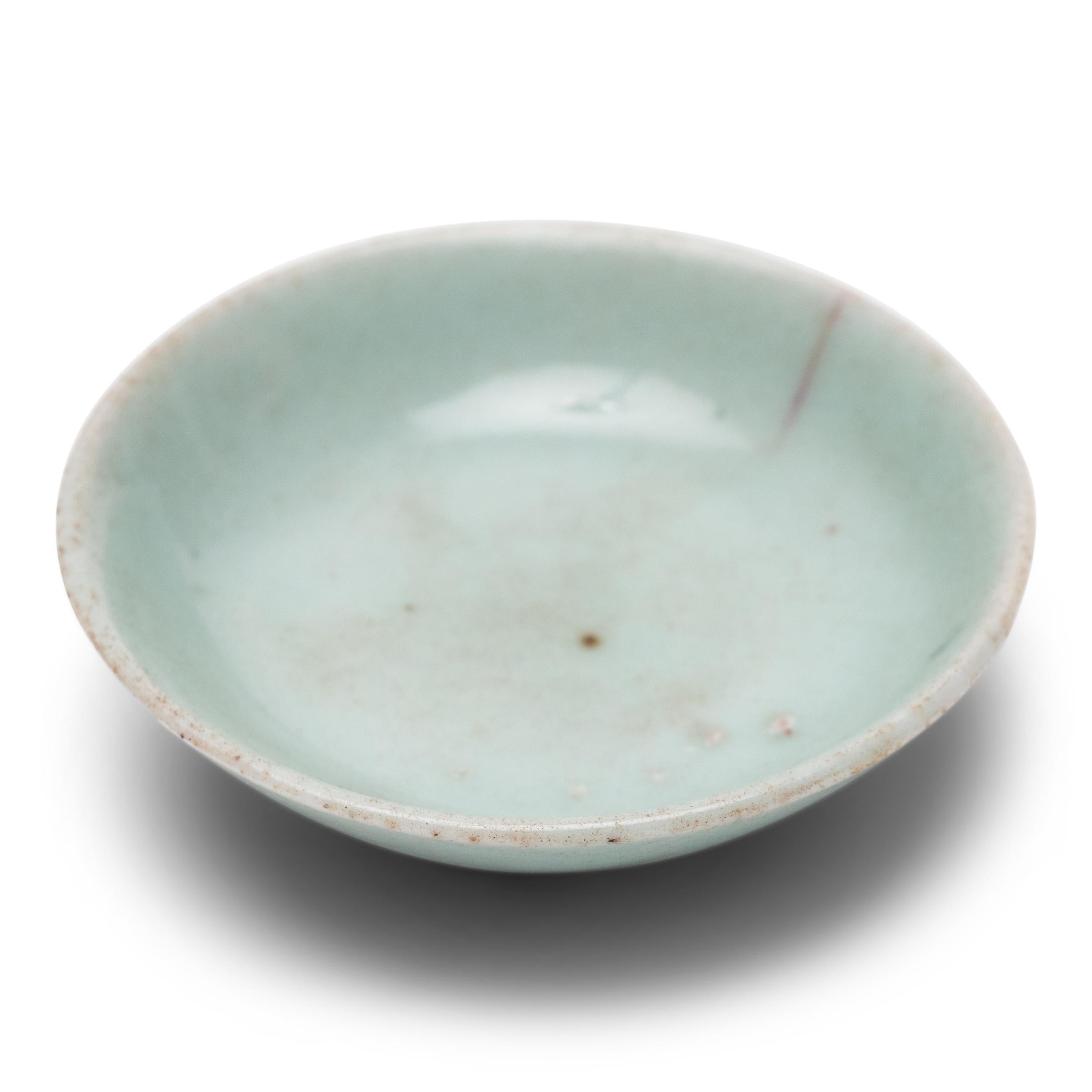 Described by ancient Chinese as a “full moon dyed with spring water,” celadon ware has long been prized for its luminous transparency and delicate blue-green coloring. This petite celadon dish has a lovely, pale blue color and a simple silhouette,