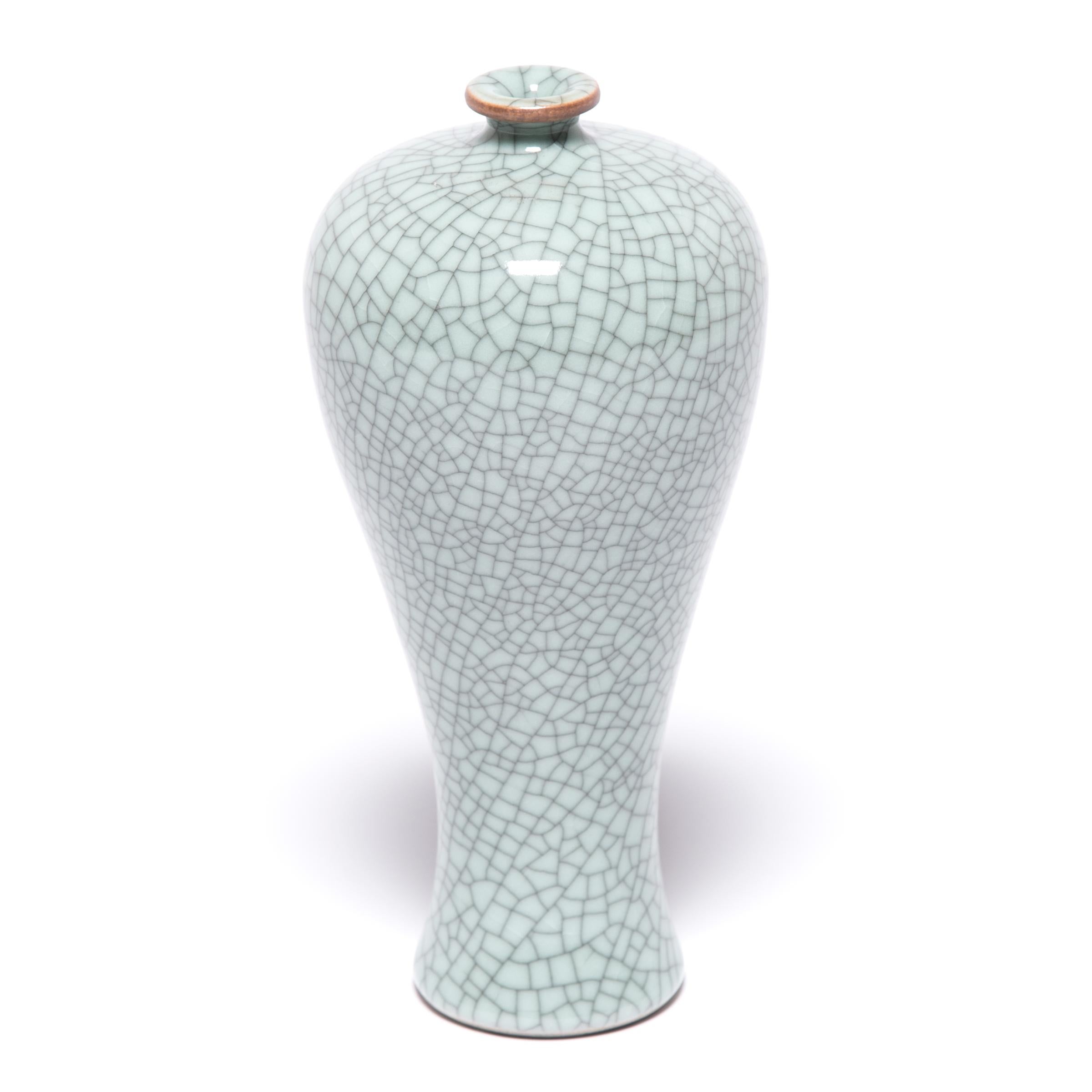 This contemporary vase hearkens to the Classic meiping form, traditionally used to display flowering plum branches. Contemporary artisans in Zhejiang beautifully recreate the distinctive crackle glaze of traditional Guan and Ge ware, allowing the