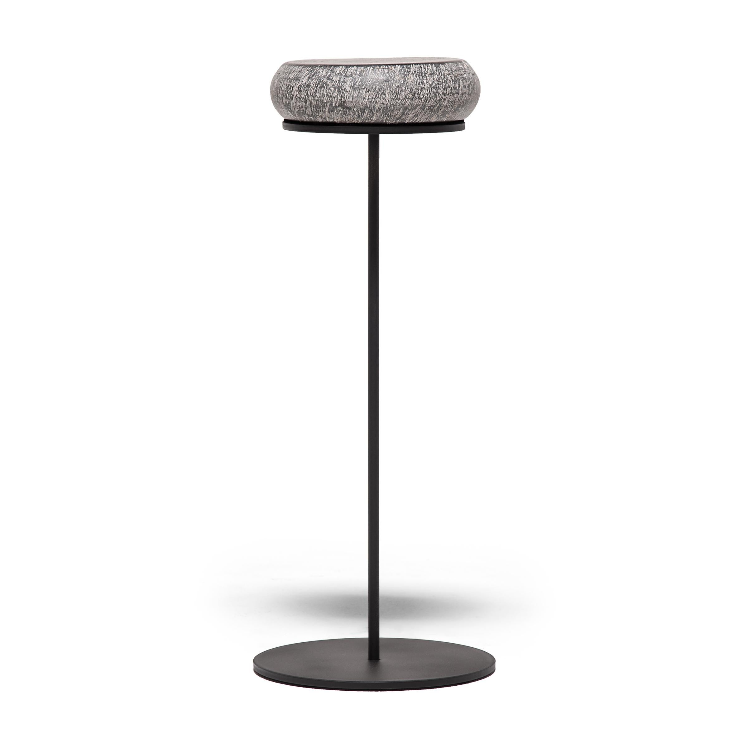The stone top of this petite drum table references the form of a traditional hand held fish drum. In Taoist mythology the fish drum was the symbol of Zhang Guolao, one of the mythical Eight Immortals. A storied eccentric, Zhang was believed to have