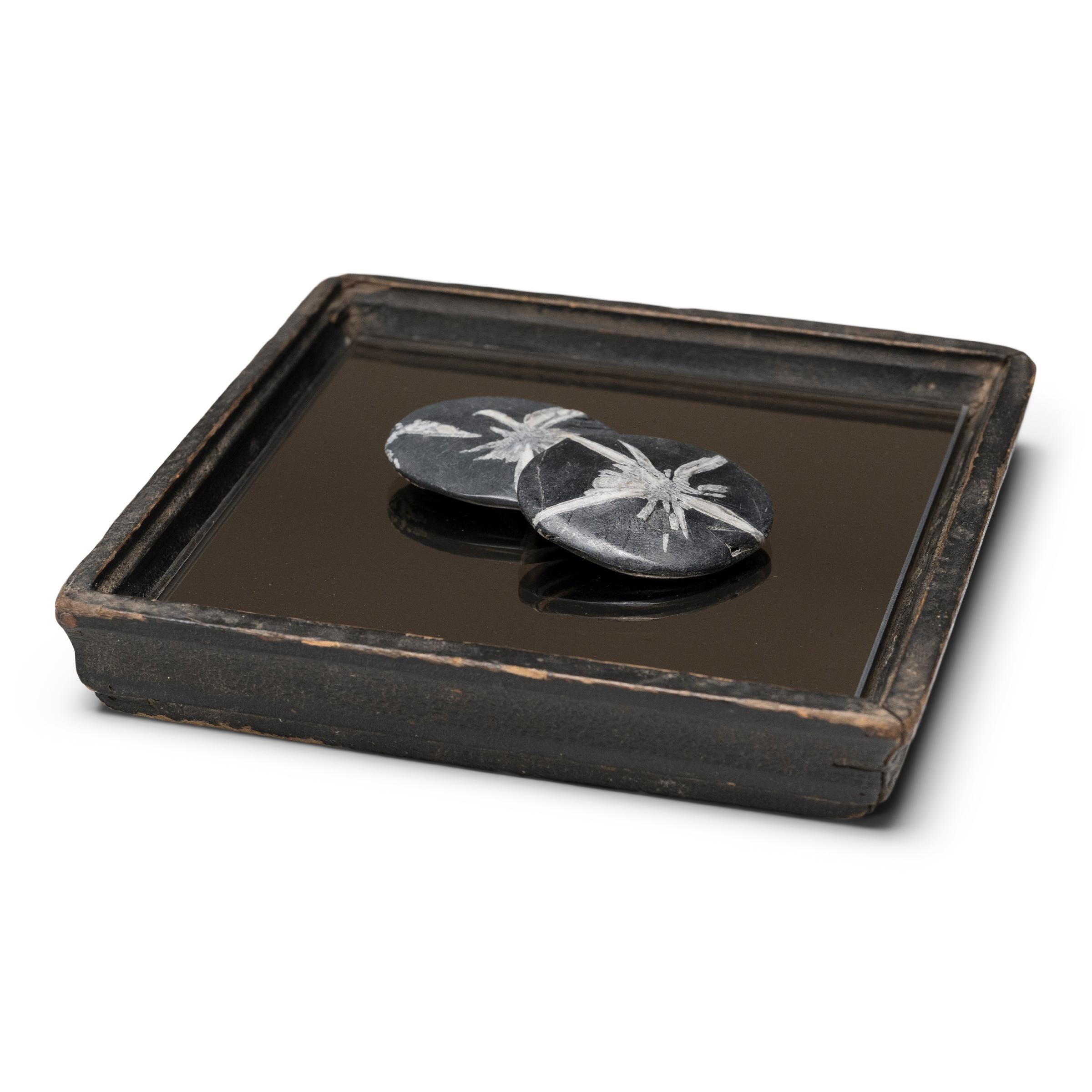 Simple lines, a modest form, and a layer of hand-brushed lacquer give this petite Qing-dynasty tray a provincial charm that recalls the warmth of home. The dark brown lacquer finish has weathered with time to reveal the light brown coloring of its