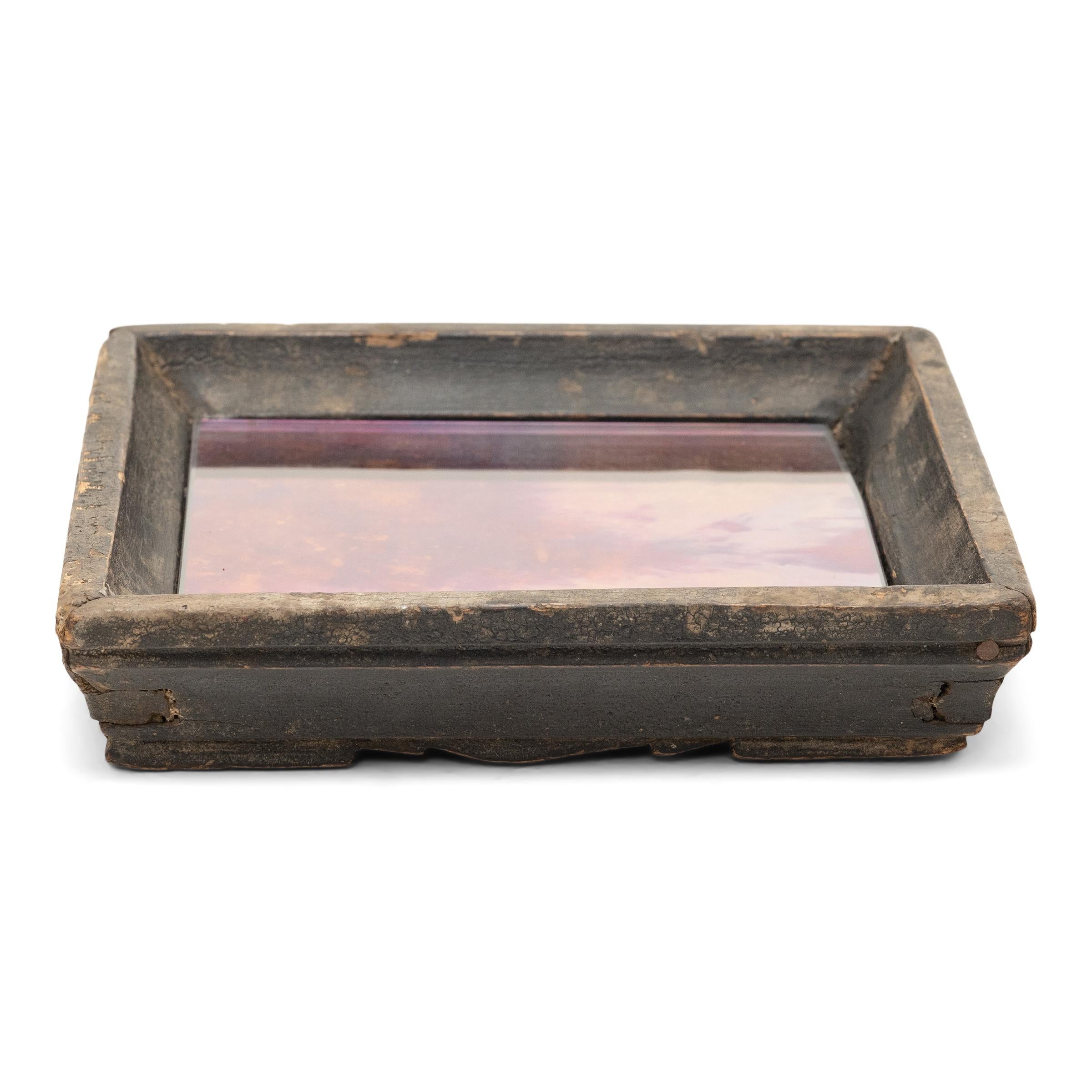 Simple lines, a modest form, and a layer of hand-brushed dark brown lacquer give this petite Qing-dynasty tray a provincial charm that recalls the warmth of home. The square tray has developed great character from years of use serving tea or food to