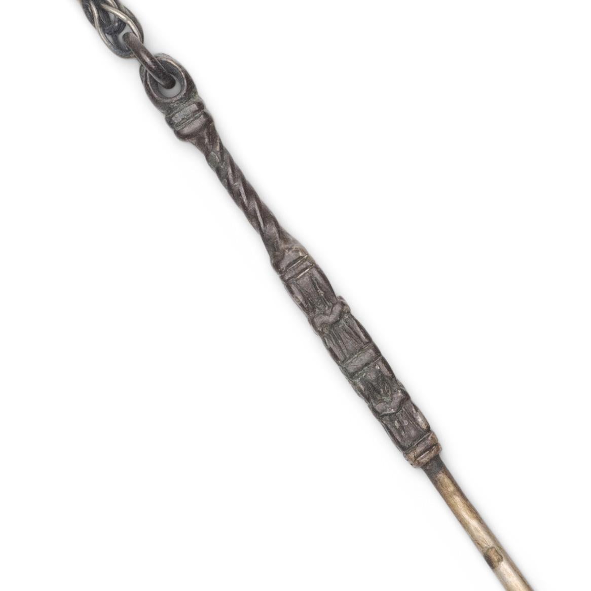 A small Chinese chatelaine tool set strung with a single brass spoon. Suspended from one's clothing at the shoulder, back, or waist, a tool set such as this was used for a variety of daily tasks, such as personal grooming, taking snuff, or cleaning