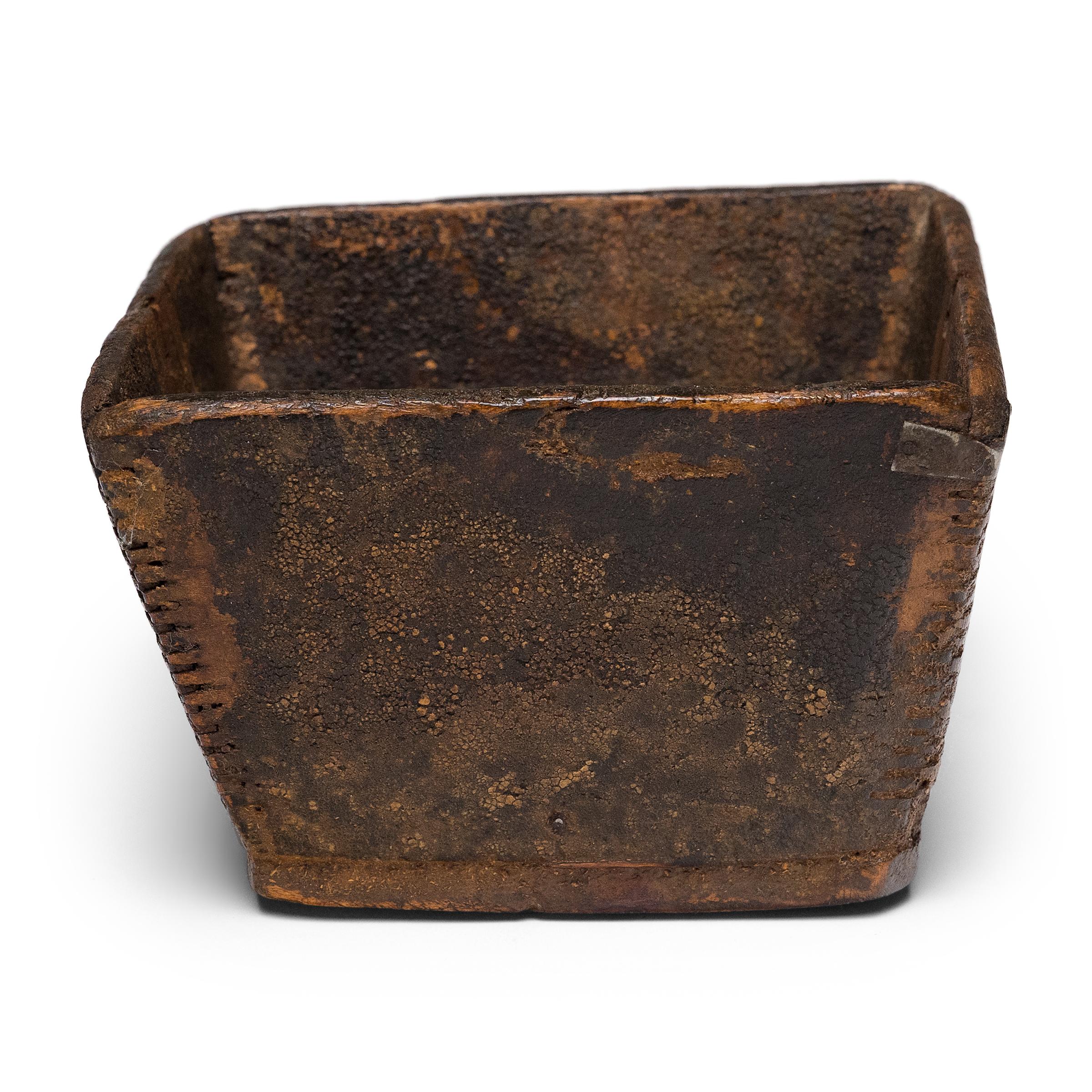 This rustic, wooden container is an early 20th century rice measure, used to portion out servings of dry rice and other grains. In keeping with the larger rice measures used at market, the little tray has a square, tapered form with finger joinery