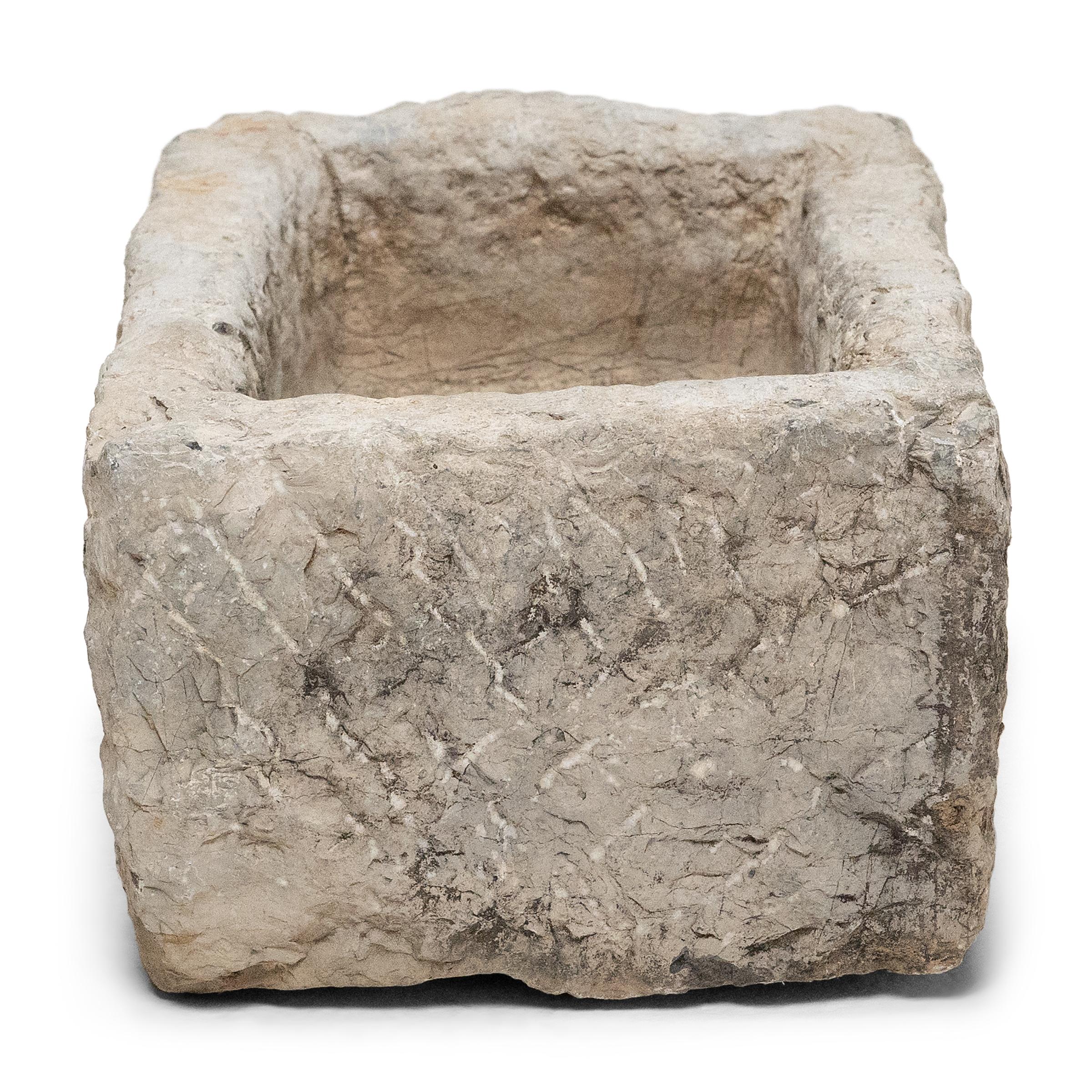 Once used on a provincial Chinese farm to hold water or animal feed, this early 19th-century stone trough is celebrated today for its organic form and rustic authenticity. The trough is hand-carved from solid limestone with a rectangular form,