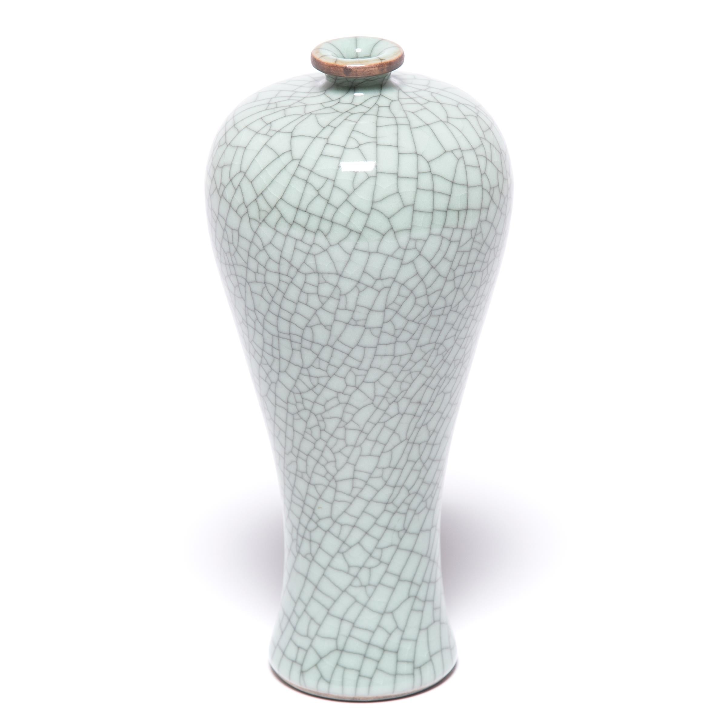 This contemporary vase hearkens to the classic meiping form, traditionally used to display flowering plum branches. Master ceramic artists in Zhejiang beautifully create the distinctive crackle glaze of traditional Guan and Ge ware, allowing the