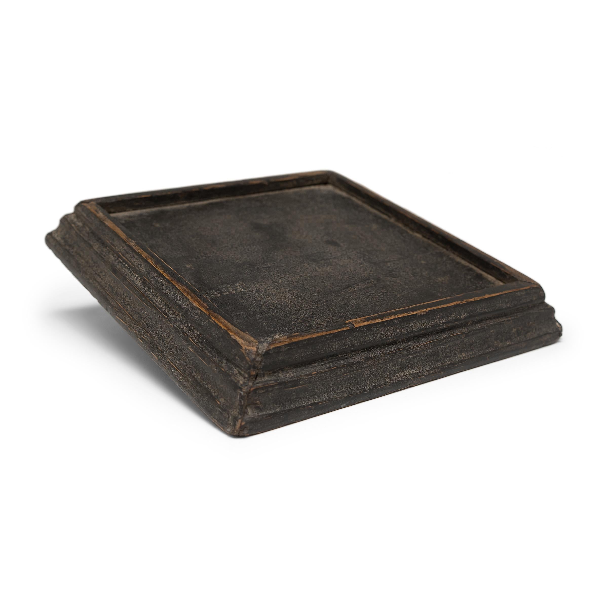 Simple lines, a modest form, and a layer of hand-brushed lacquer give this petite Qing-dynasty tray a provincial charm that recalls the warmth of home. The smoky brown lacquer finish has weathered with time to reveal the light brown coloring of its
