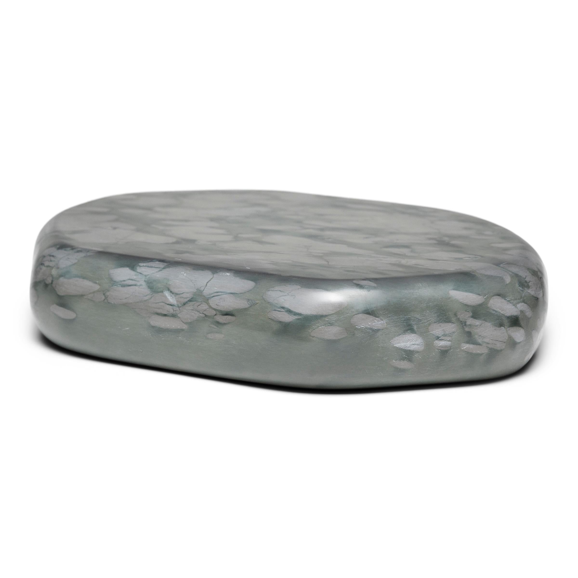 This small stone slab tray is formed of zhenzhu stone, a conglomerate limestone extracted from Lake Tai in China's Jiangsu province. Speckled with painterly daubs of color, the blue-grey puddingstone has been prized by scholars for centuries as a