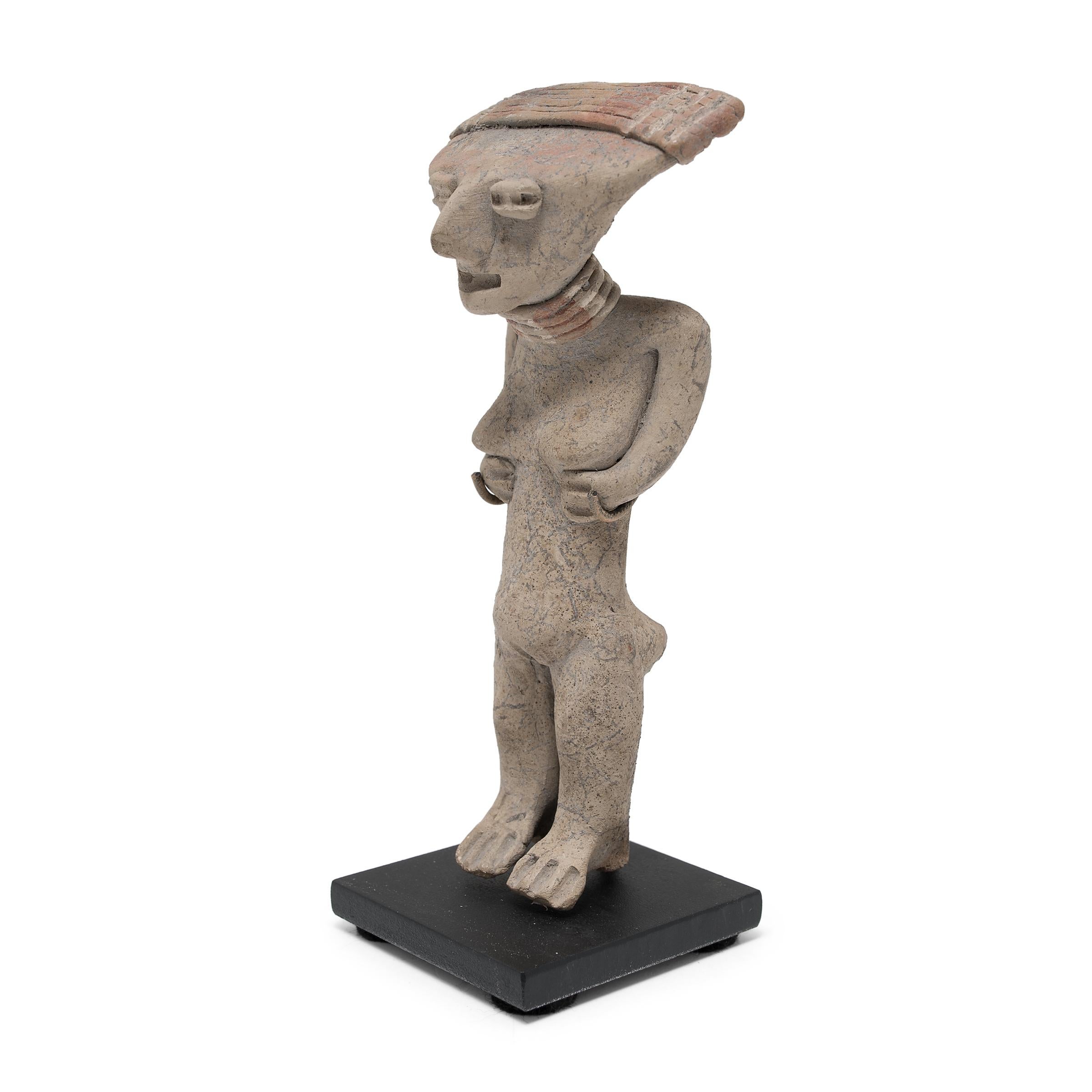 This standing female figure was crafted in 400-100 BC from the ancient Chupicuaro region of Mexico. The ceramic works of the Chupicuaro people are distinguished by their slanted, coffee-bean shaped eyes and flattened features. This particular