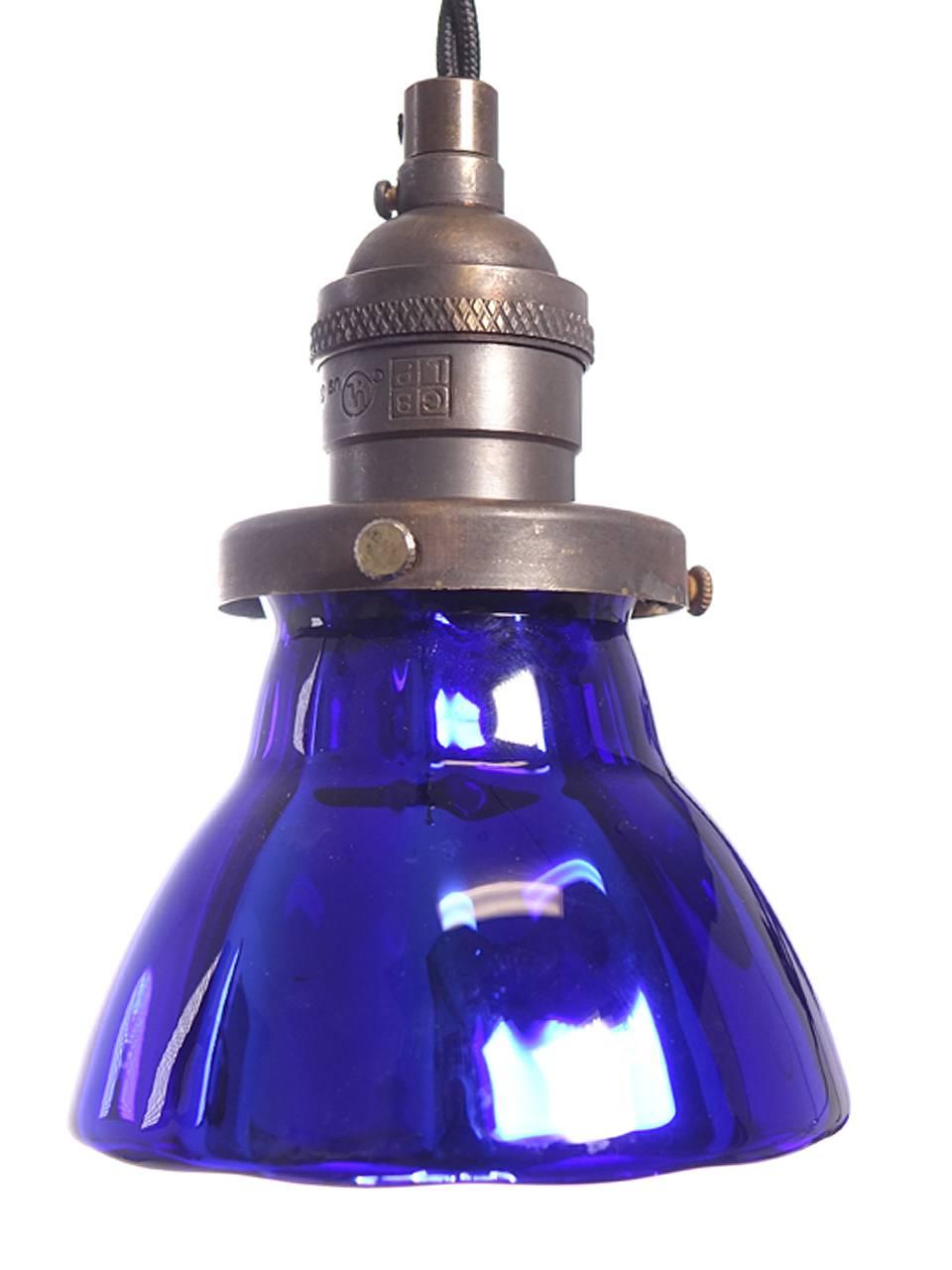 These deep blue pendants are small but striking. They are hollow handblown blue glass that is mirrored inside. It has a subtle panelled shape that nicely catches the light. These are perfect hung in groups. These lamp shades were a short limited
