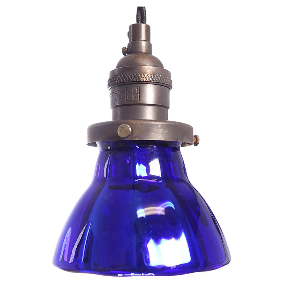 These deep blue pendants are small but striking. They are hollow hand blown blue glass that is mirrored inside. It has a subtle panelled shape that nicely catches the light. These are perfect hung in groups. These lamp shades were a short limited